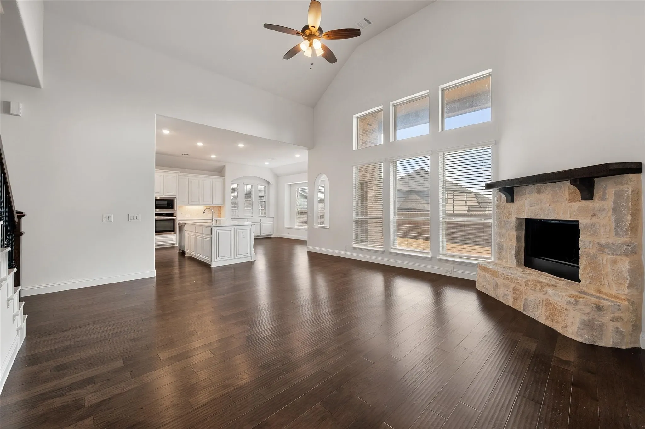 The living room with it's vaulted ceilings and natural lighting opens up into the kitchen area.