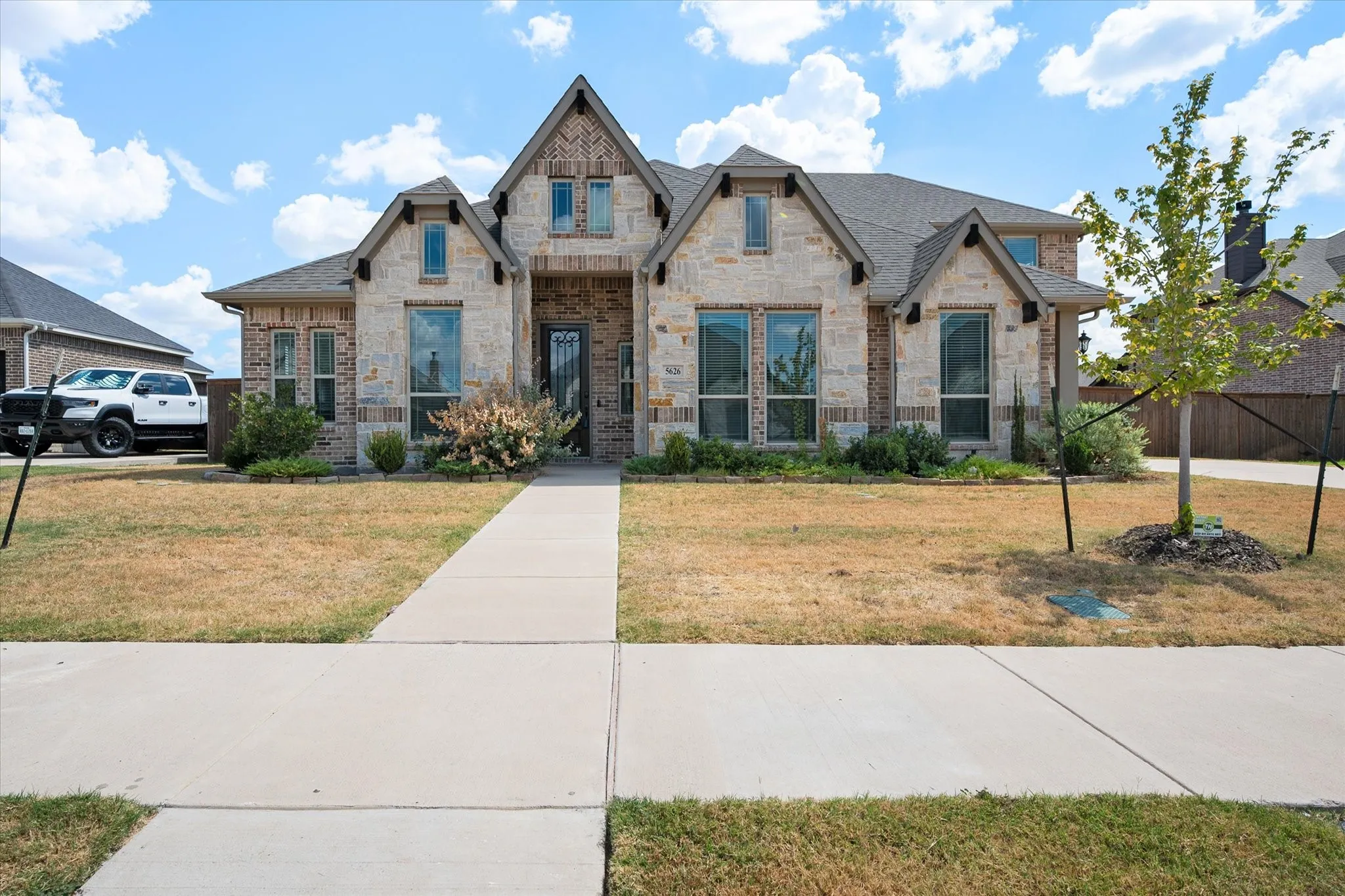 The neighborhood offers coinvent sidewalks leading up to the front of the home.