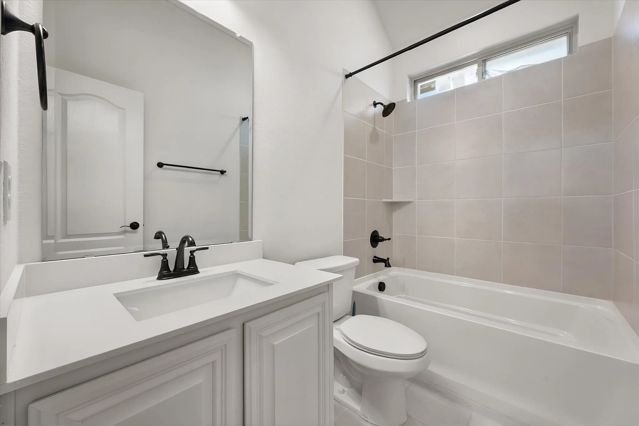 Full bath — oil-rubbed bronze fixtures, a deep soaking tub, and the window up top lets in natural light without sacrificing privacy.