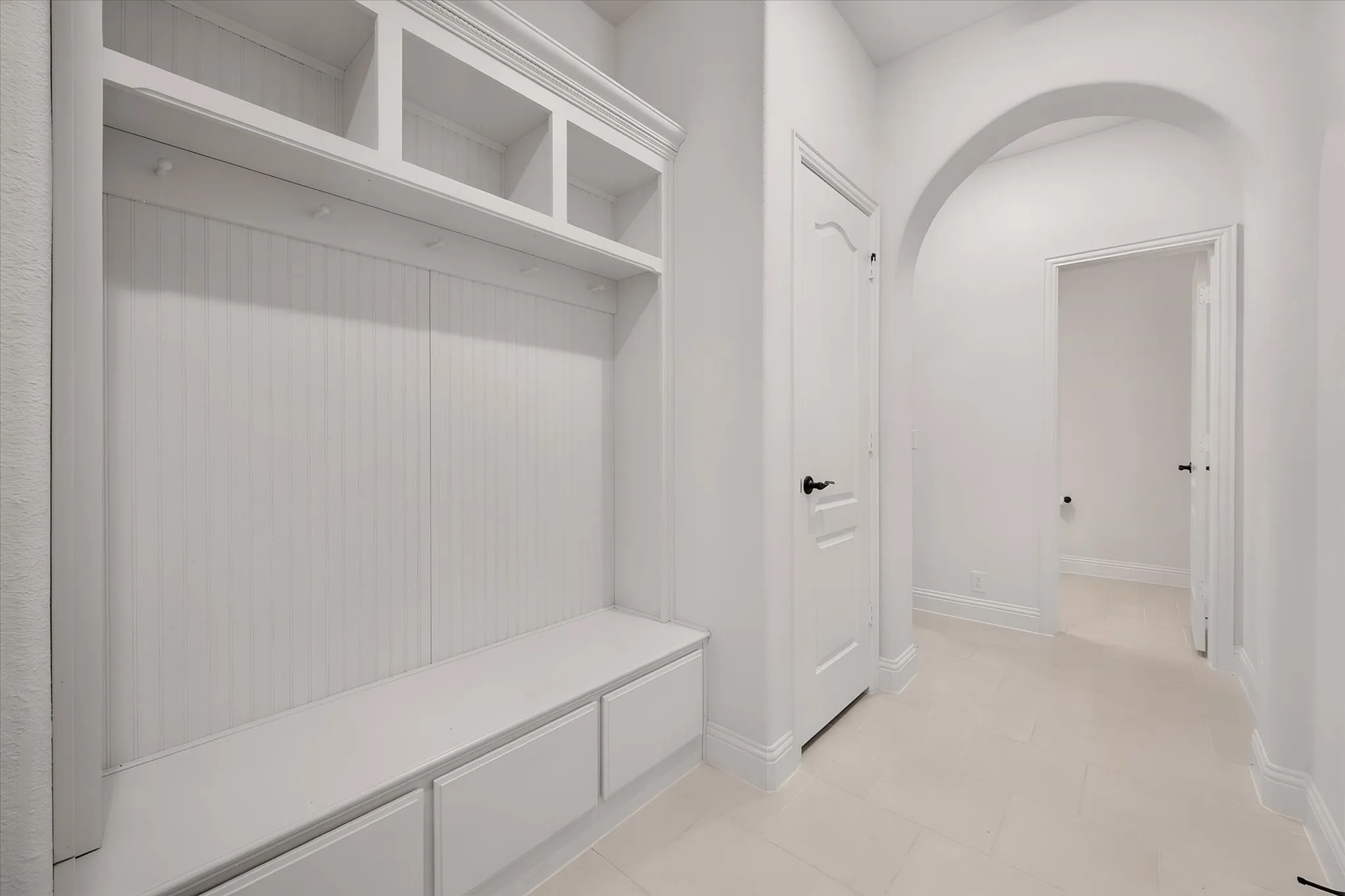 This built-in mudroom bench is such a smart feature — cubbies up top, a bench to sit on, drawers below. This is where backpacks and shoes go to live, keeping the rest of the house tidy.