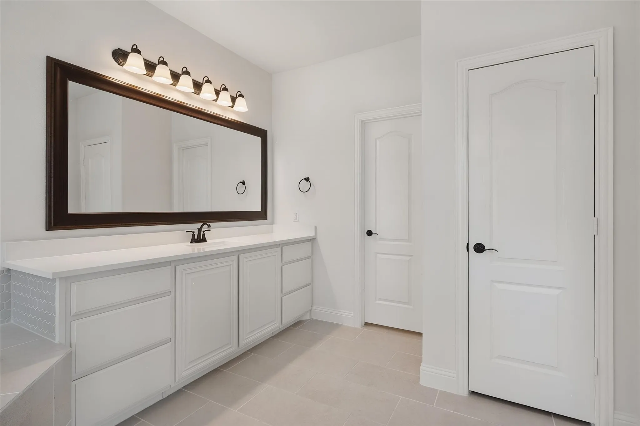 Here's the second vanity — plenty of counter and drawer space, plus doors leading to the water closet (private toilet door) and closet.