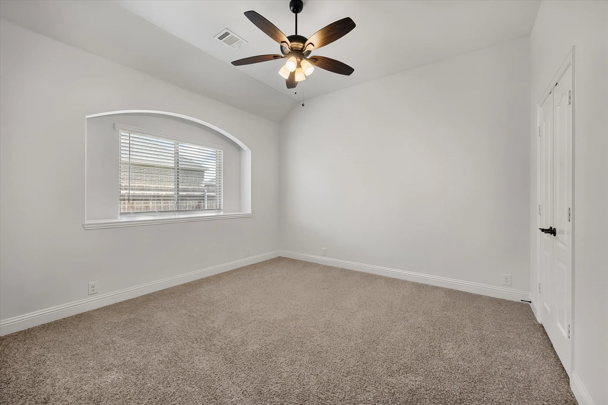 Another great bedroom on this level — I love that arched window, it's such a nice architectural touch, and there's a big closet just to the right for all your storage needs.