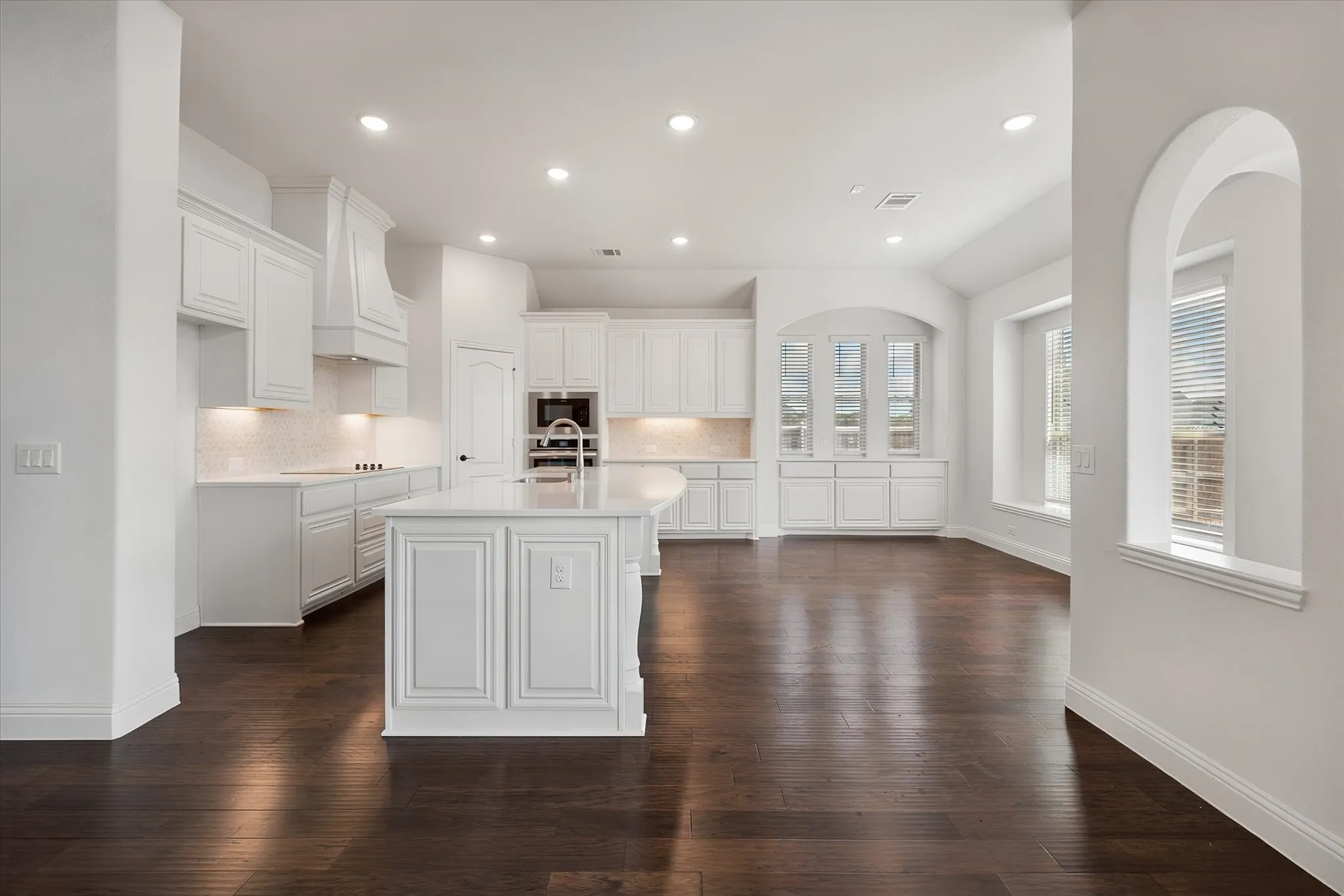 Now for my favorite part — this kitchen! White cabinetry, a huge island with seating.