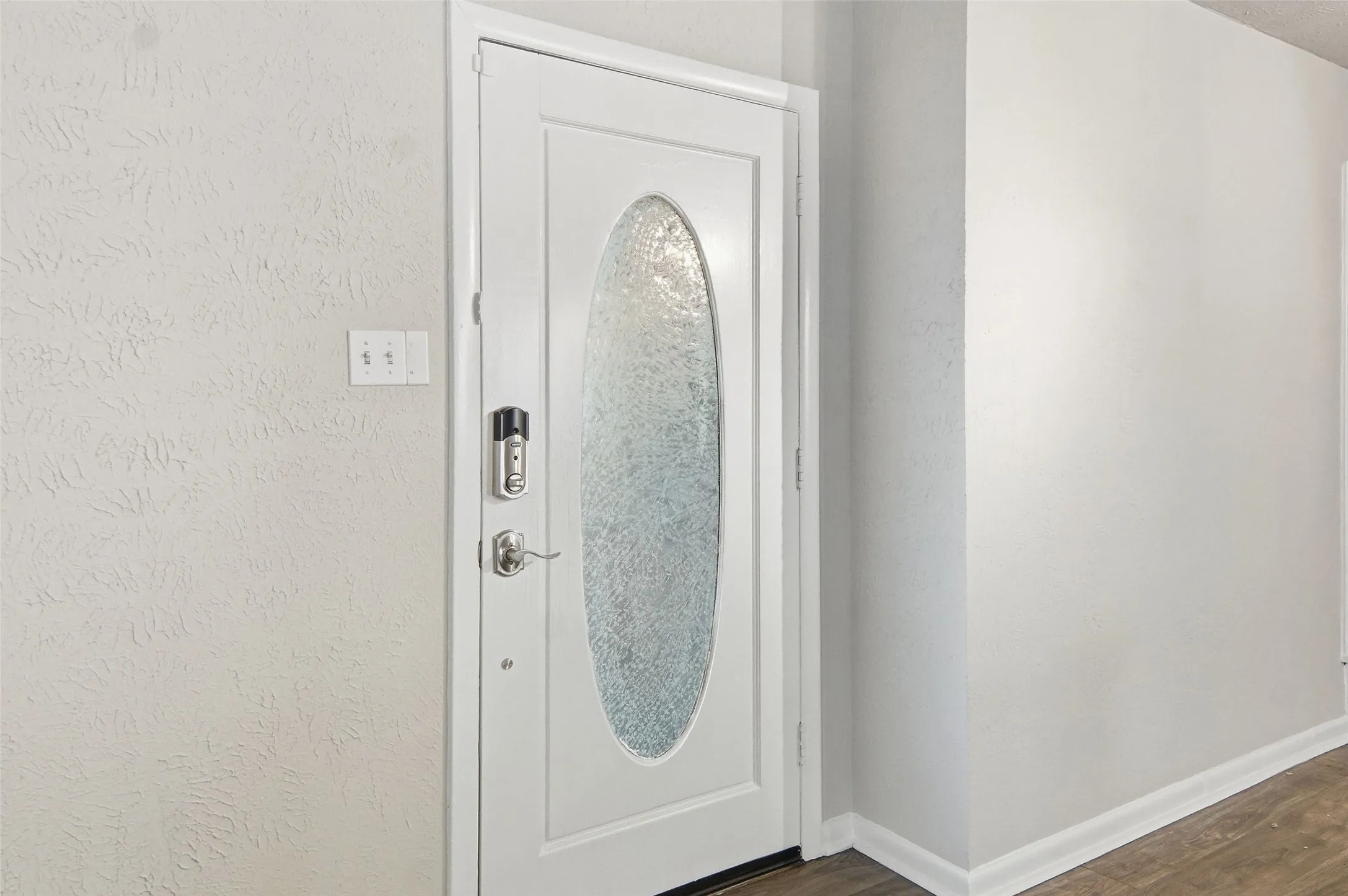 Lovely leaded glass door leads to the living room.