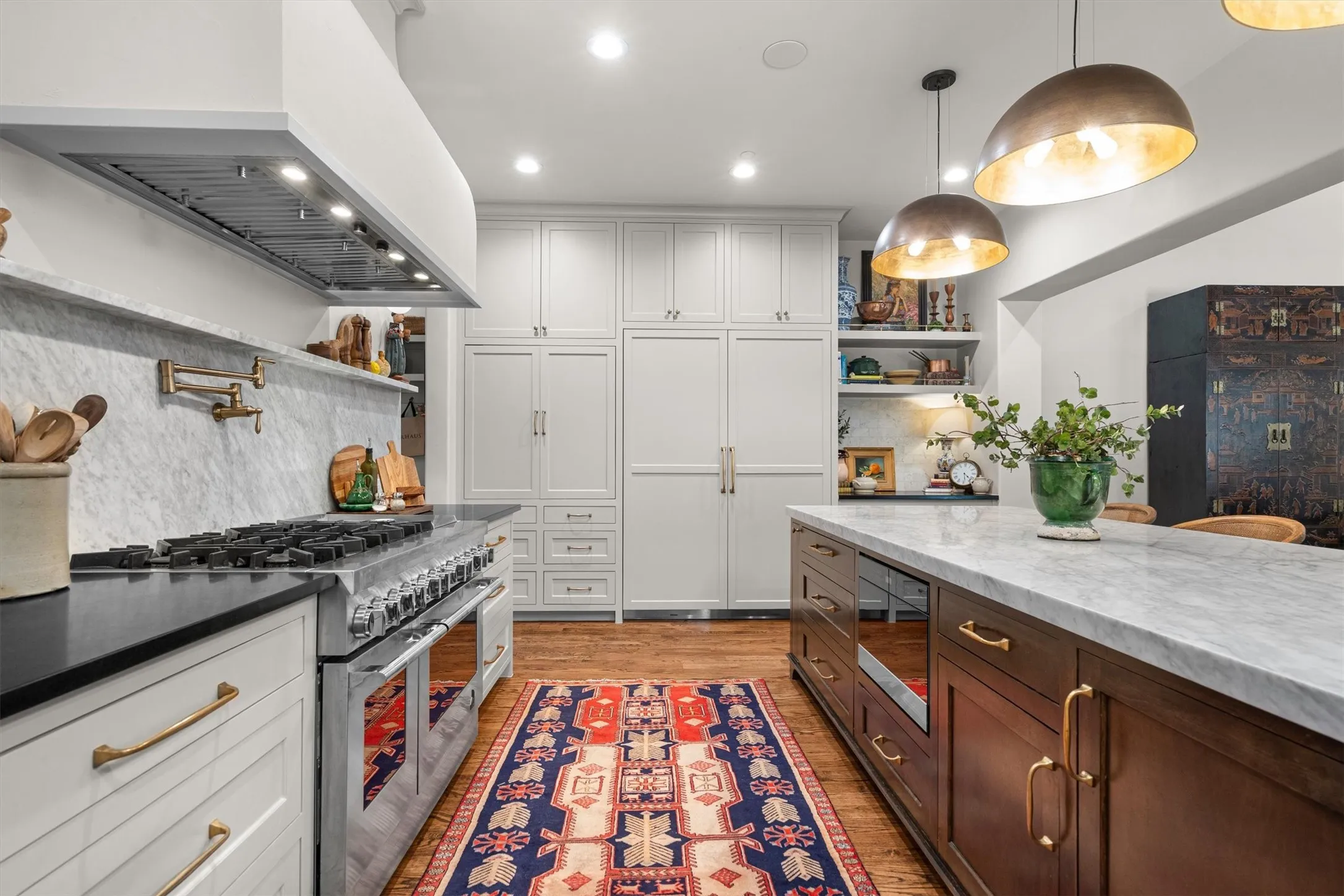 Professional-grade range with pot filler and designer tile backsplash — a true cook's dream.