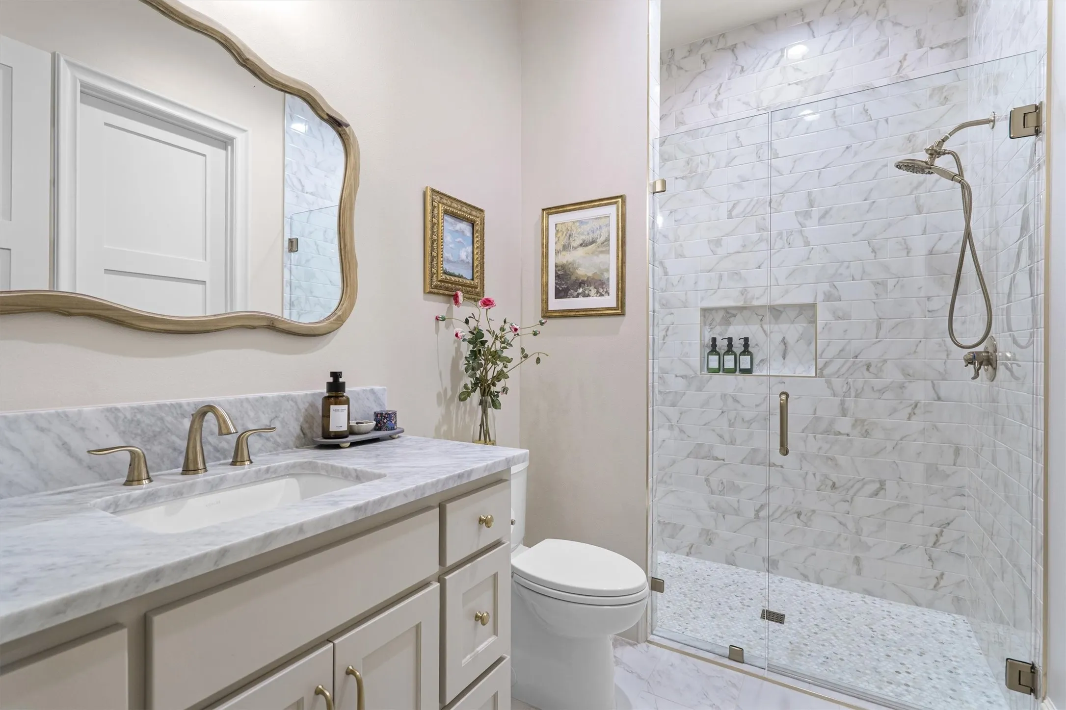  Well-appointed secondary bath with sleek glass shower and modern fixtures.
