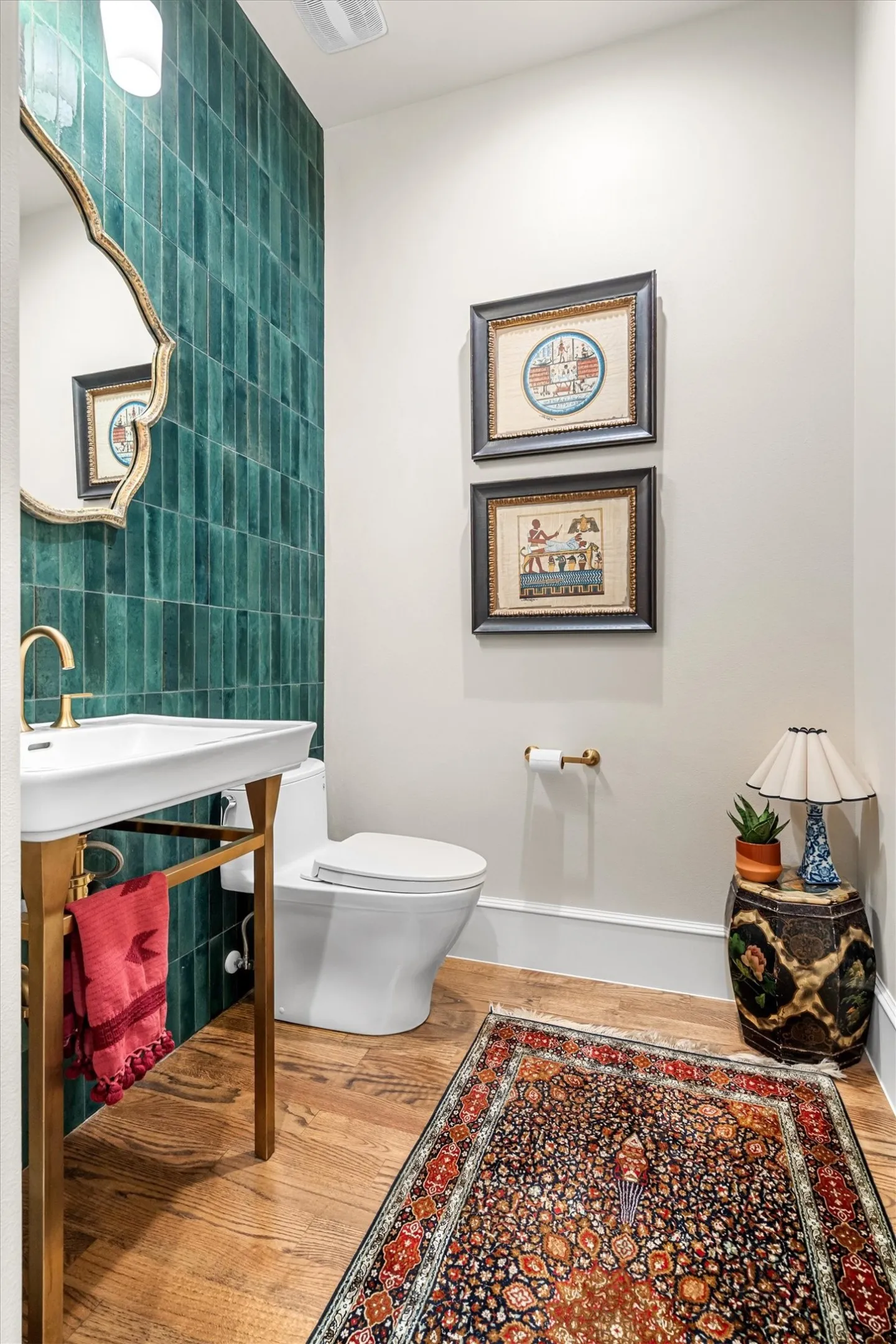 Designer powder bath with striking teal tile accent wall.