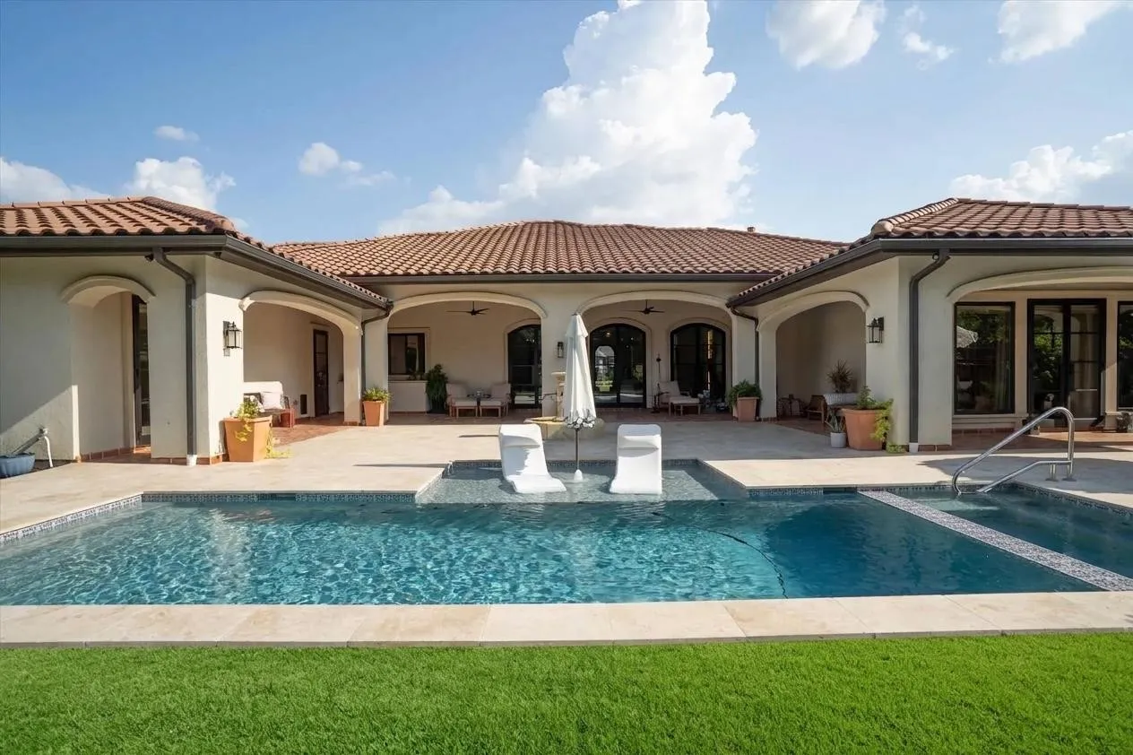 Resort-style pool with spa and manicured backyard — your private oasis awaits.