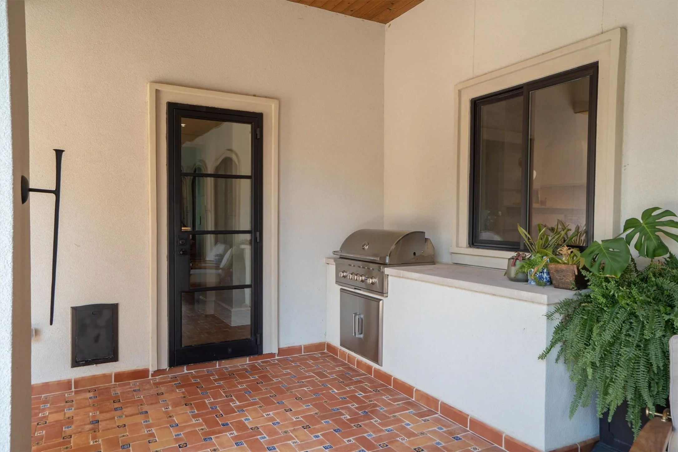 Covered outdoor kitchen with built-in grill — ready for year-round entertaining.
