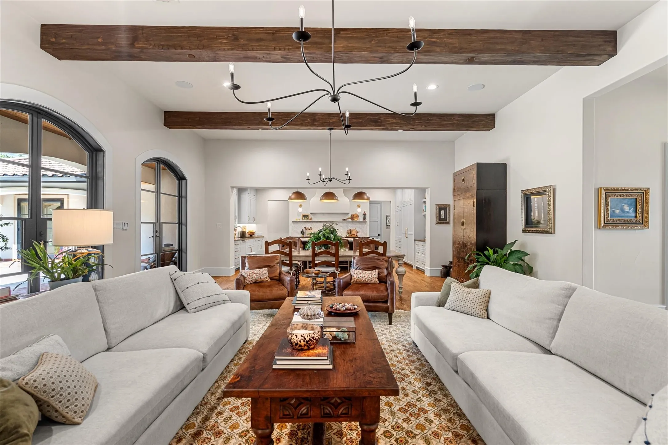 Sun-filled living space with French doors to the backyard and warm hardwood floors throughout.