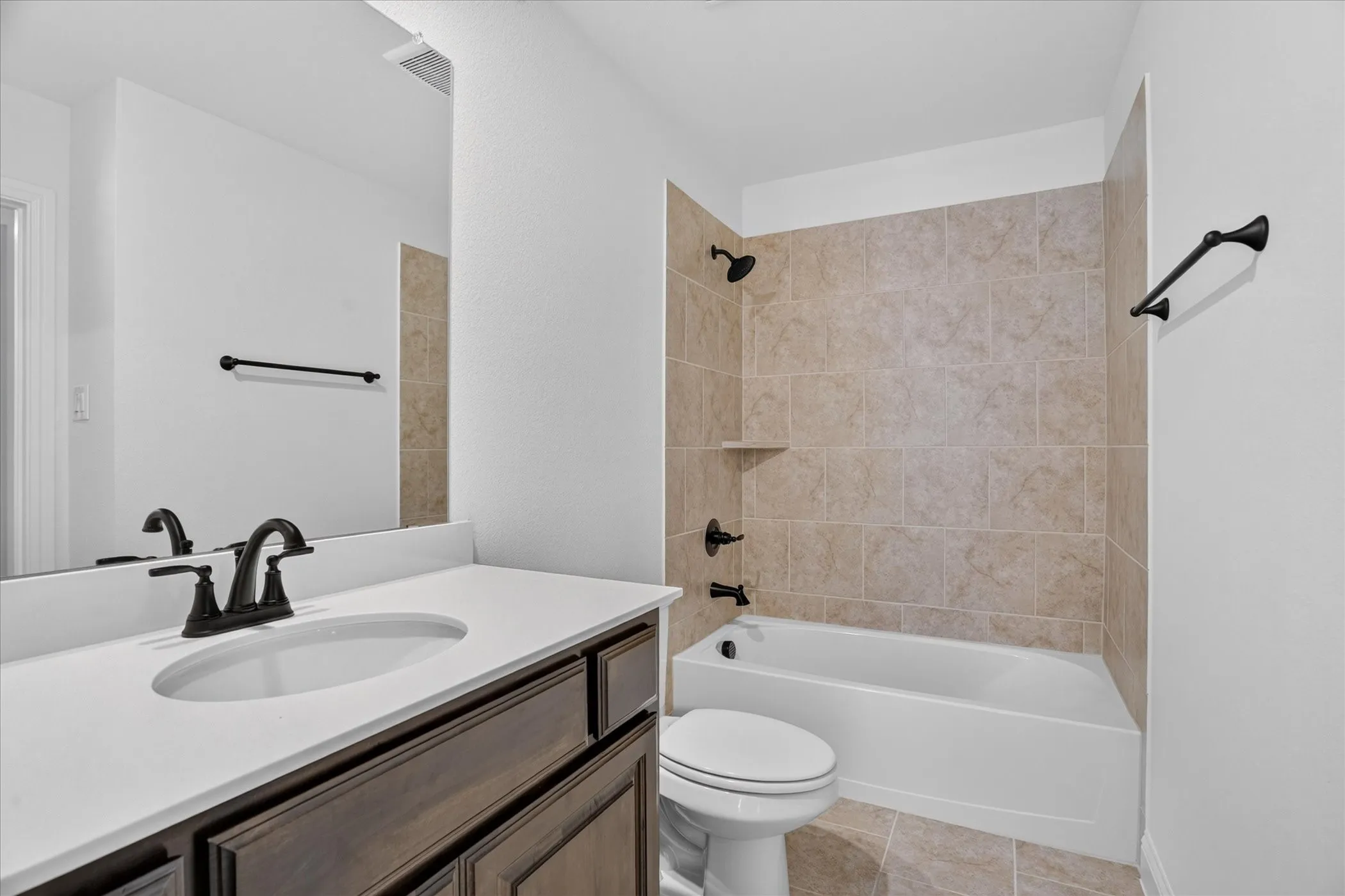 Vanity with a white countertop and dark wood-finish cabinetry