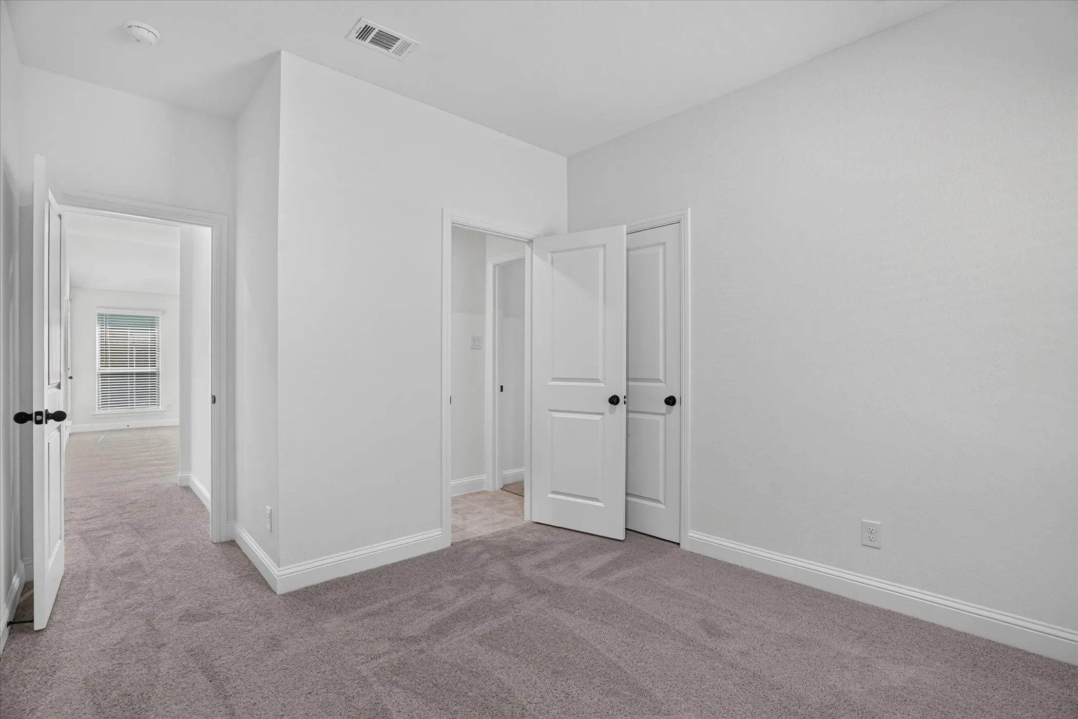 Plush carpeting throughout with white baseboards
