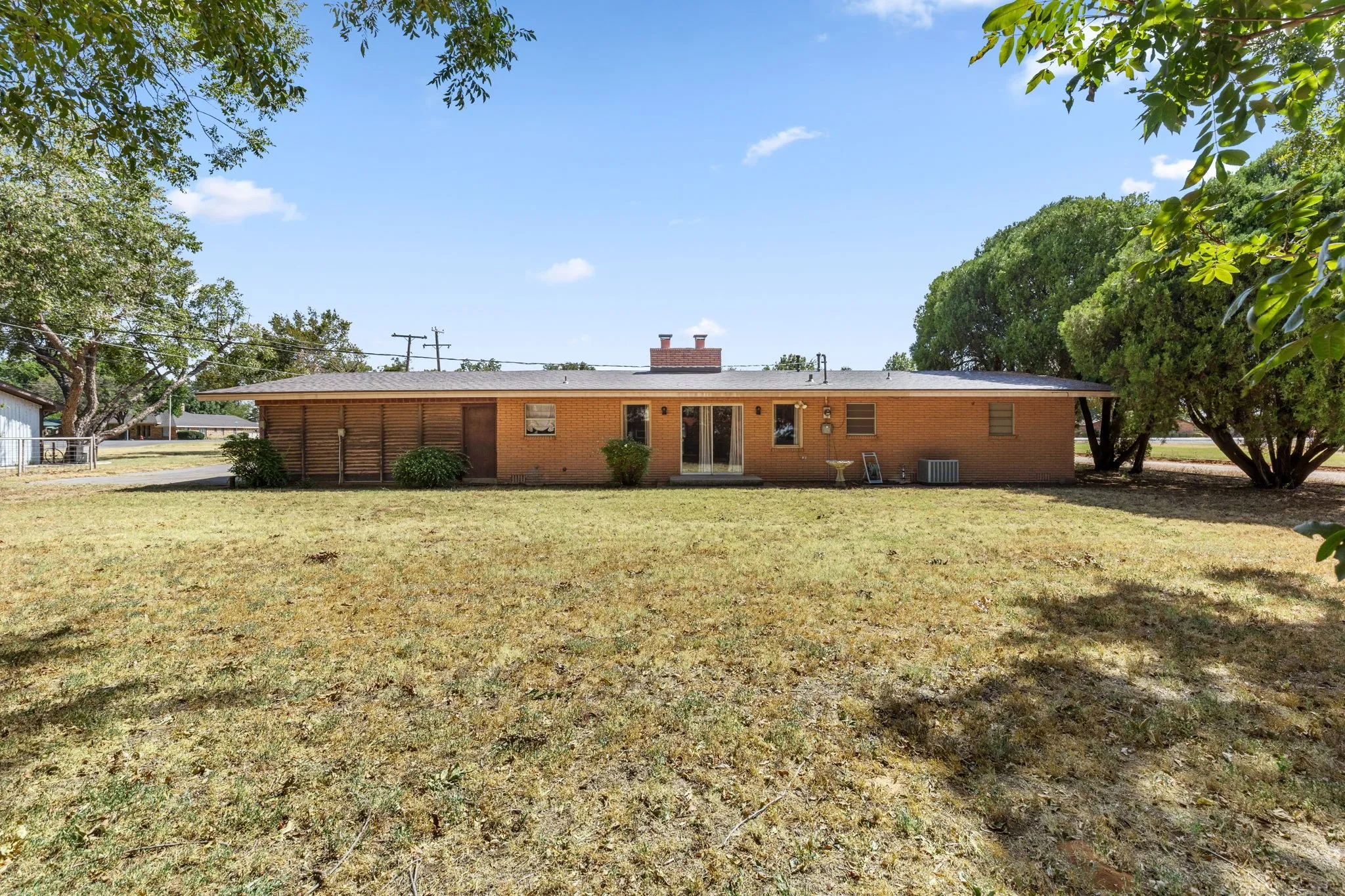 Brick exterior with multiple windows and a central double door