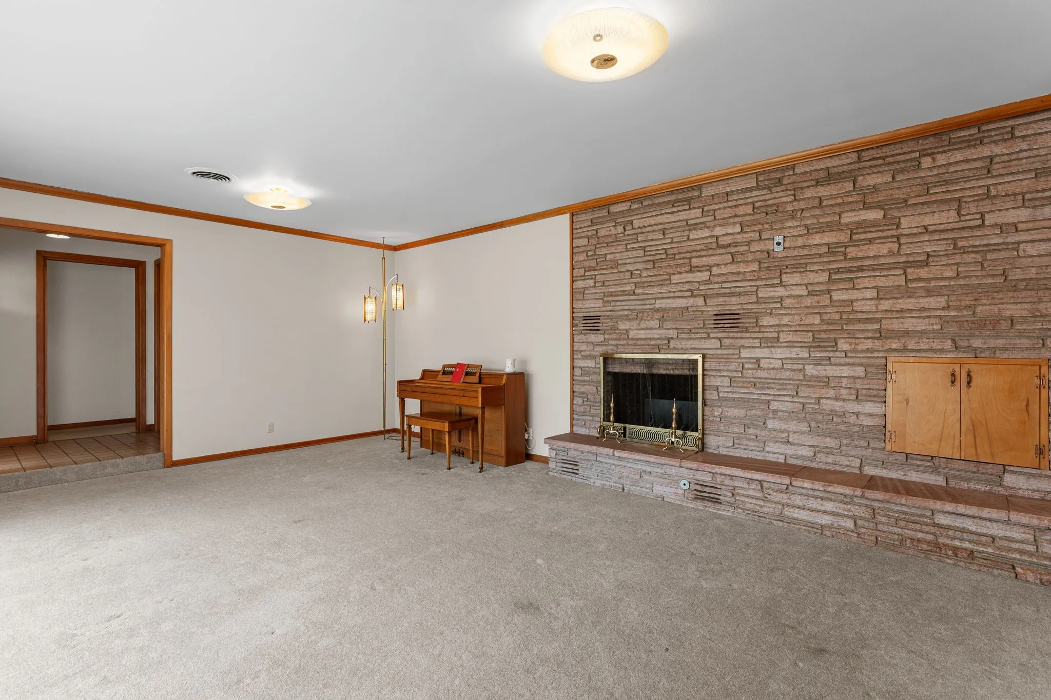 Stone accent wall with a built-in fireplace and hearth
