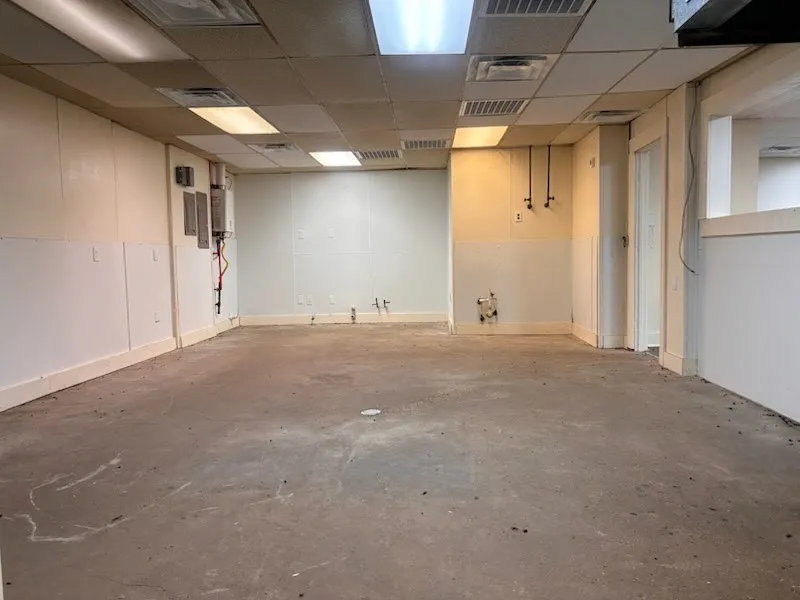 Concrete flooring and white paneling
