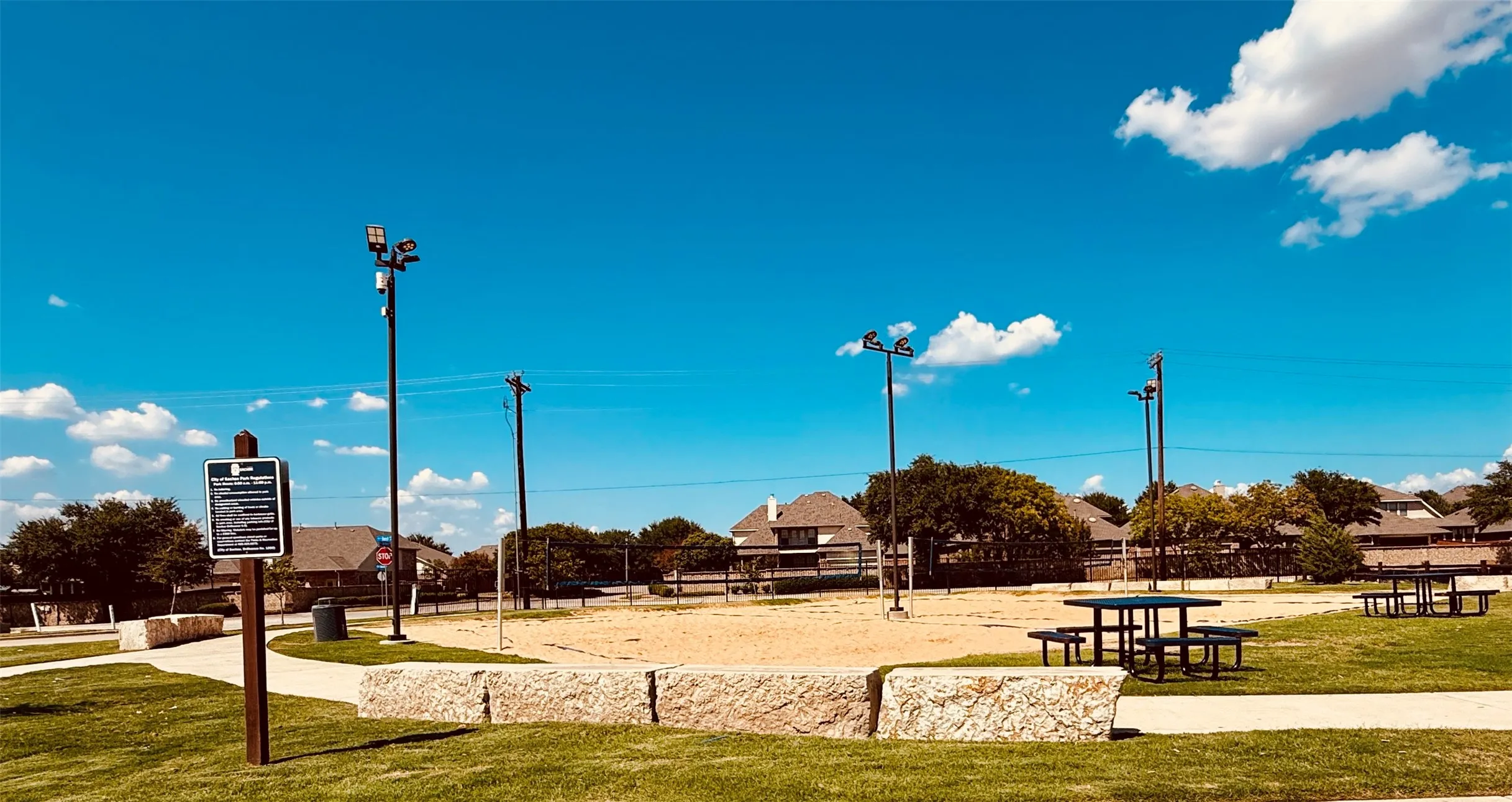 Sachse City Park recreational area featuring two sand volleyball courts and picnic tables.