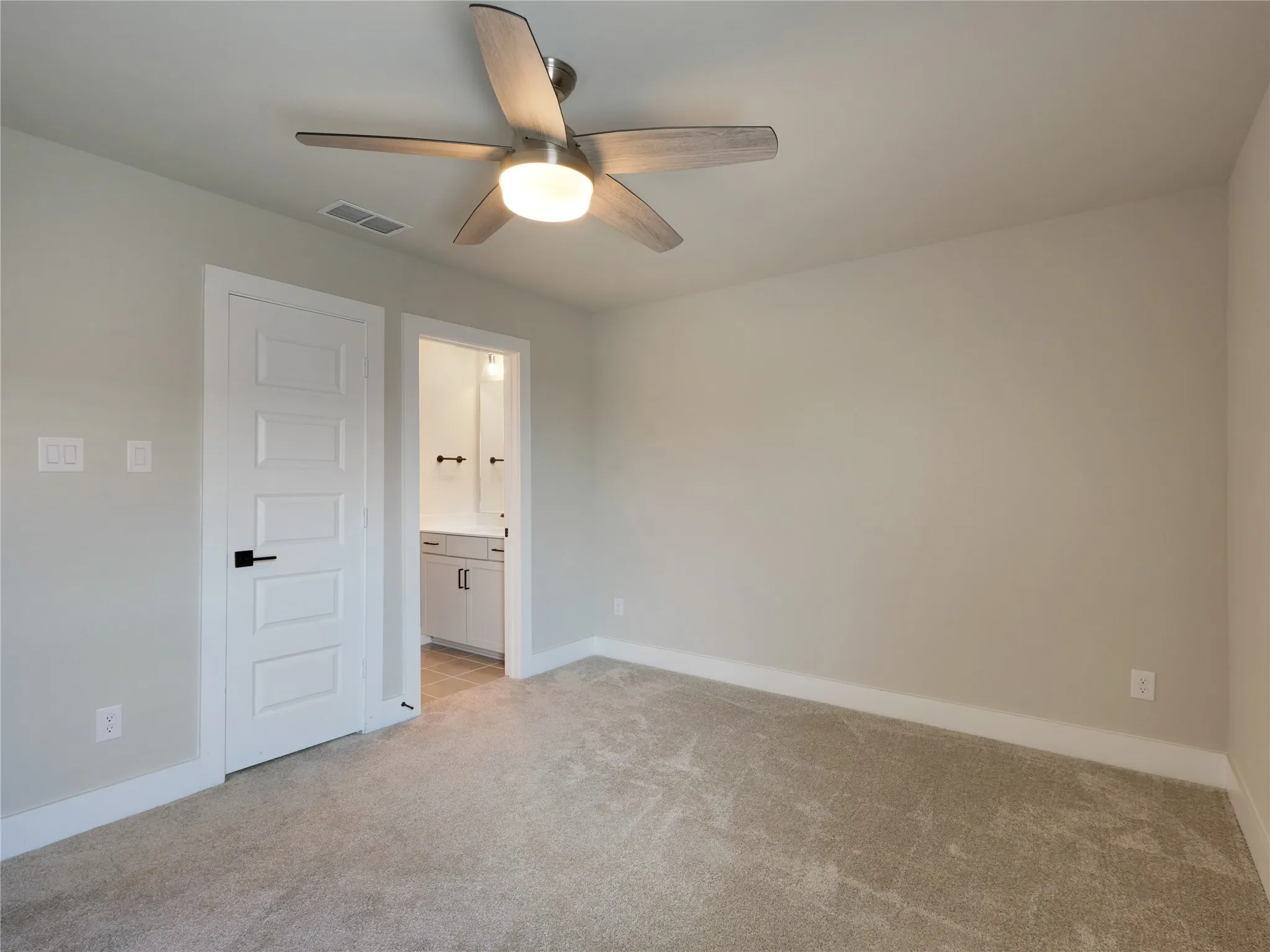 Bedroom 3 featuring a ceiling fan, a window with blinds, and ana ensuite bath.