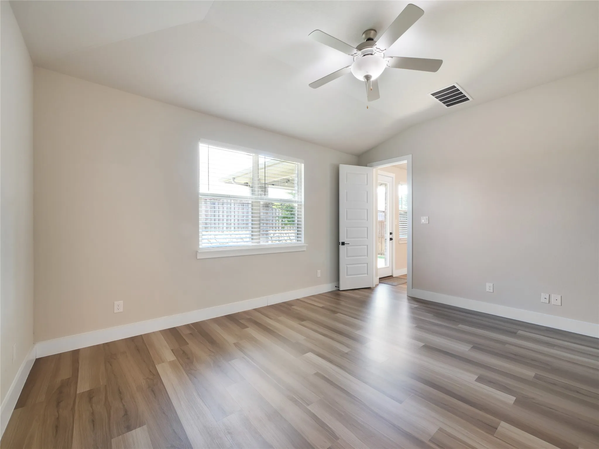 Primary bedroom overlooks the backyard.