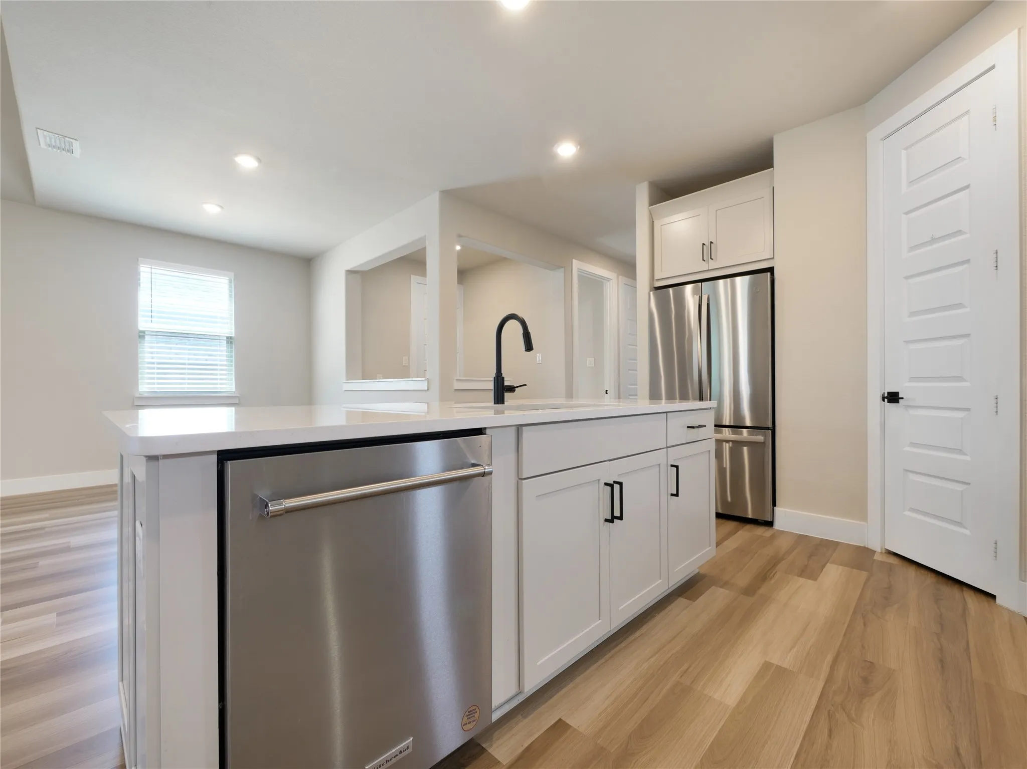 Kitchen island with stainless steel Kitchen Aid dishwasher.