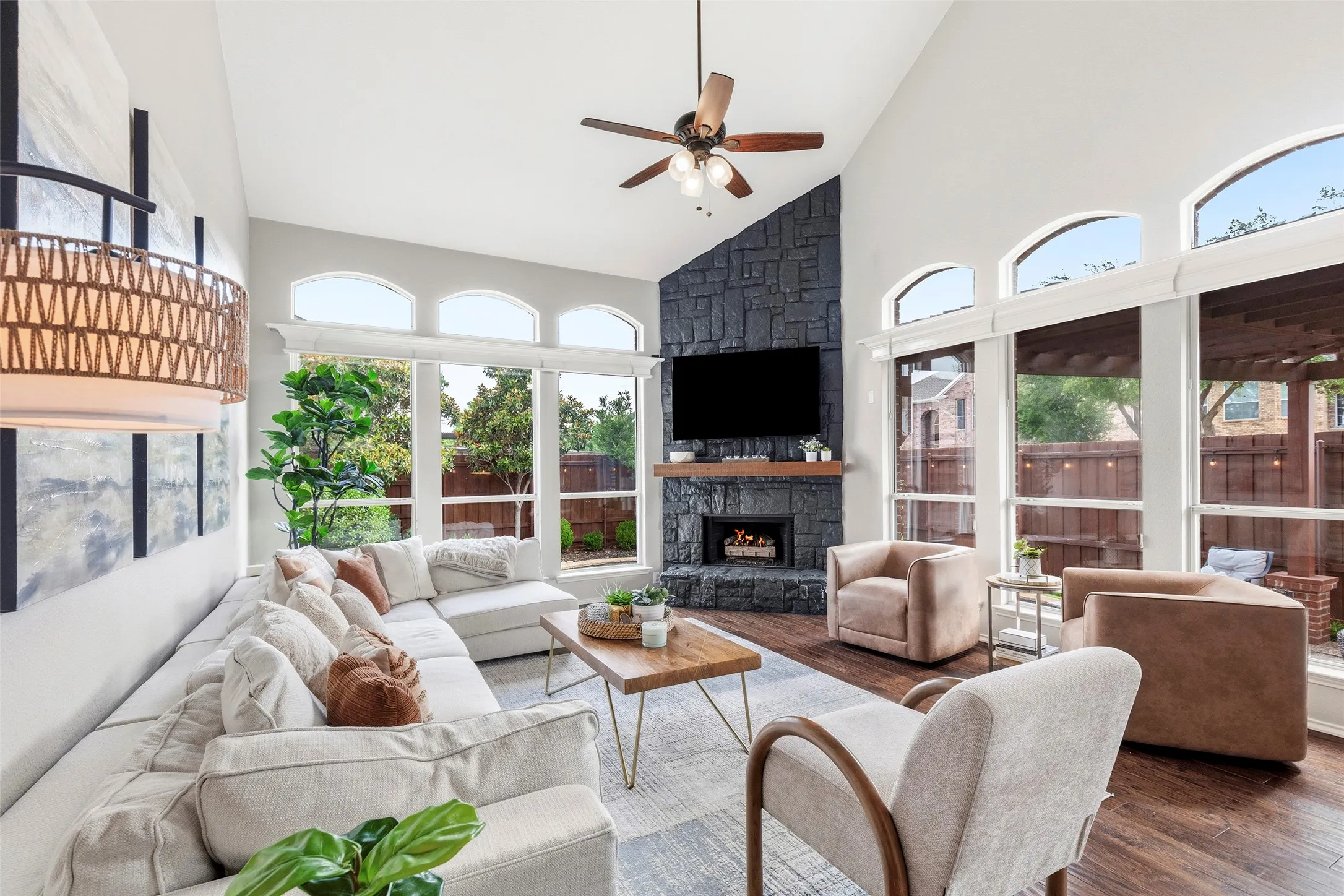 Large main living room with fireplace, overlooking swimming pool