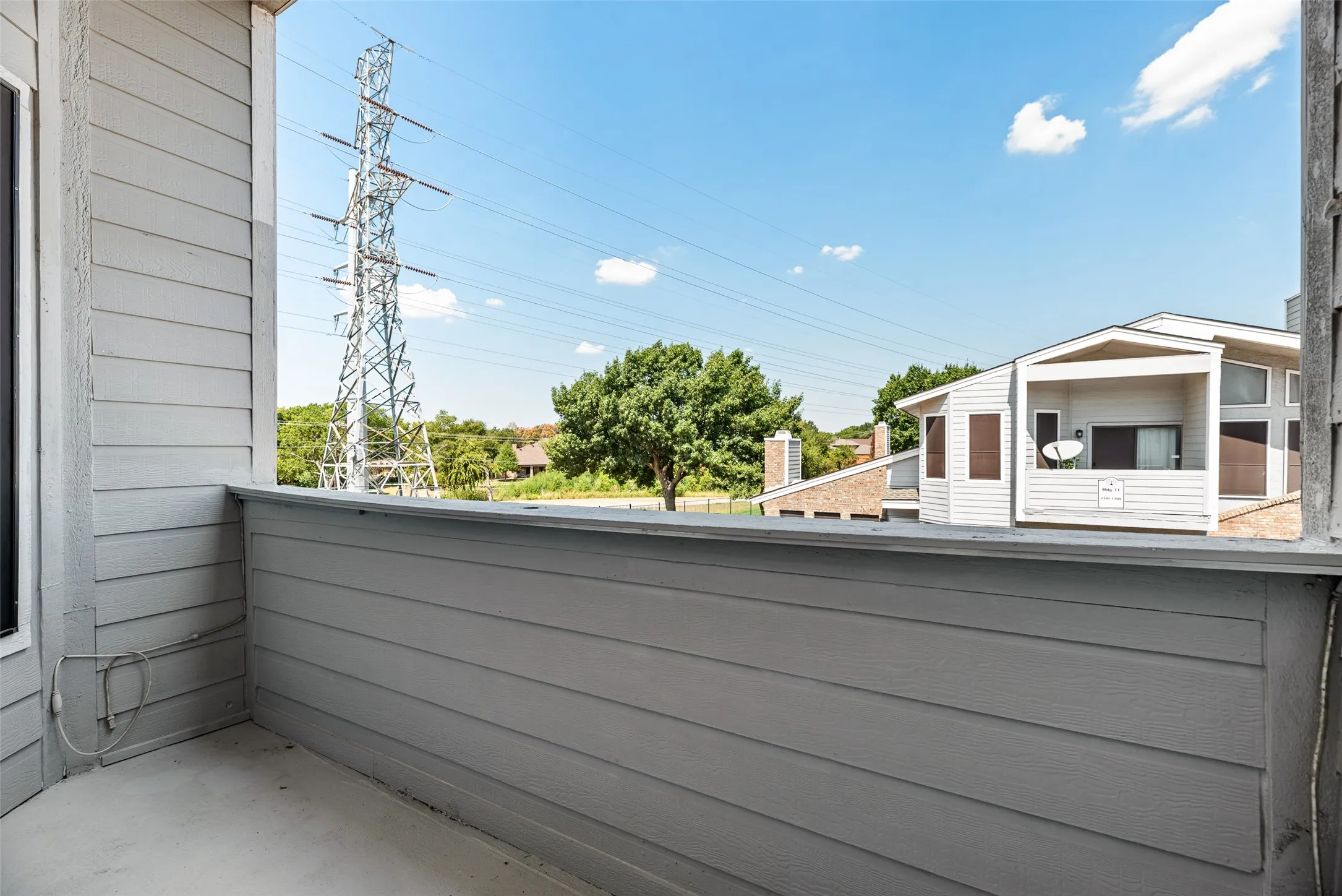 Balcony with horizontal siding and a concrete surface