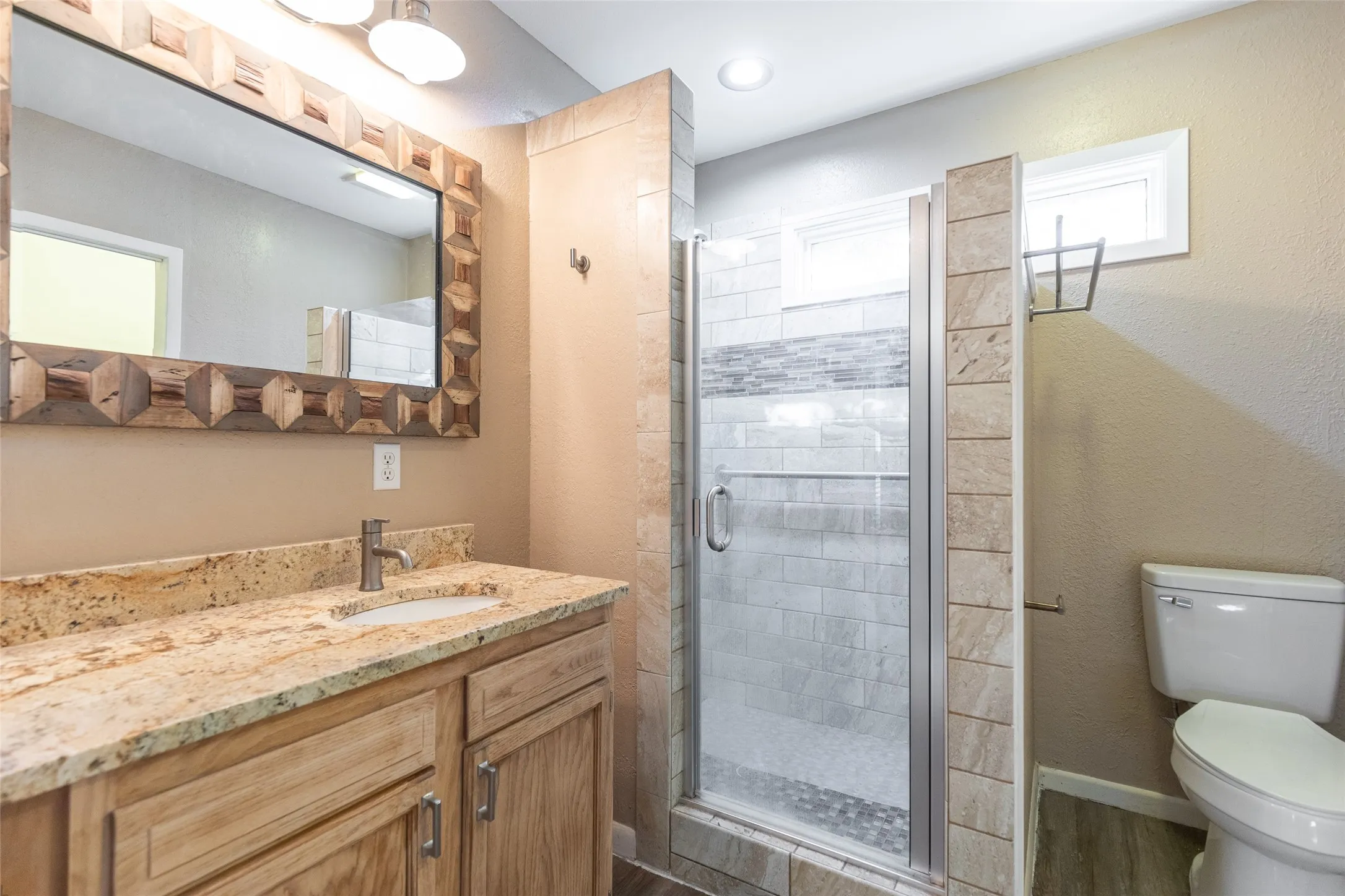 Vanity with a granite countertop and undermount sink