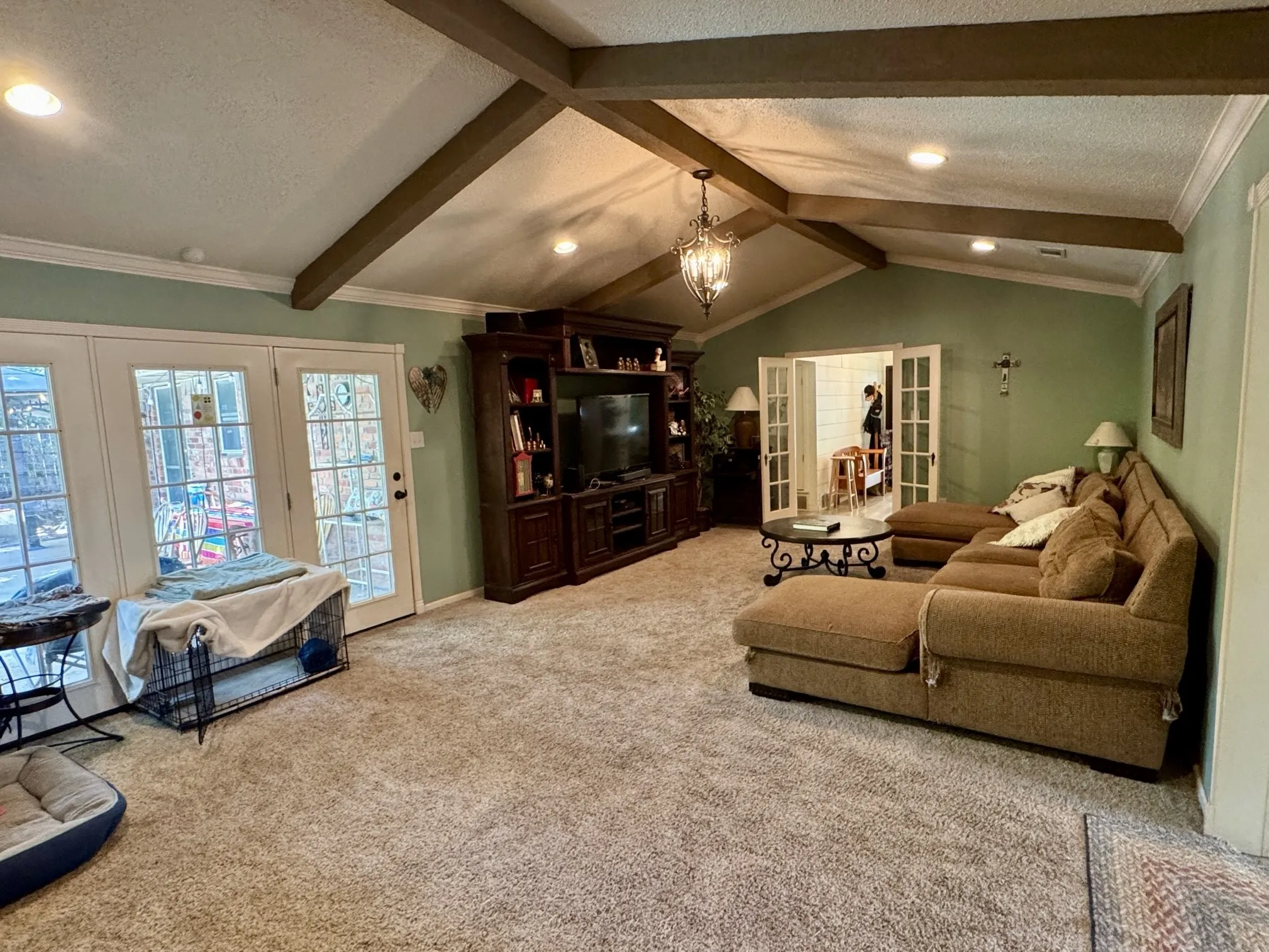 Vaulted ceilings with beams add depth and design.