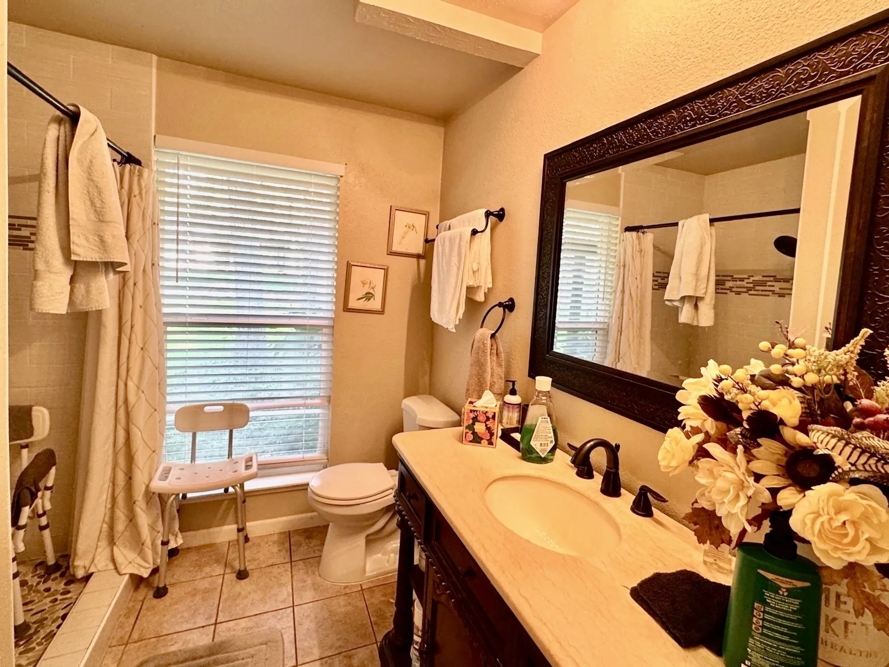 Hall bathroom with good size counter and a large window.