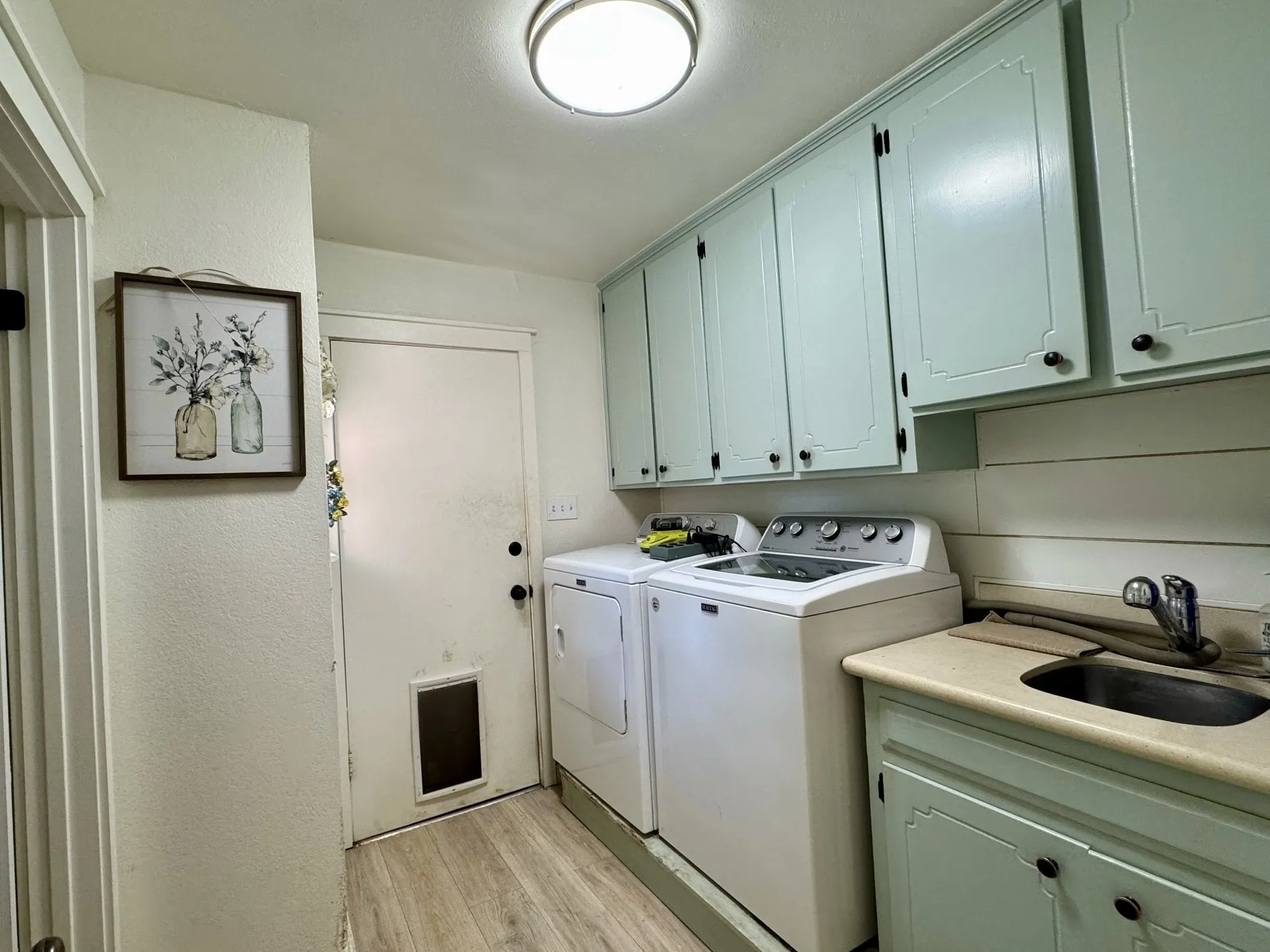 Half bath to the left. Door leading into the garage, allows for a mud/ utility room, between the kitchen.