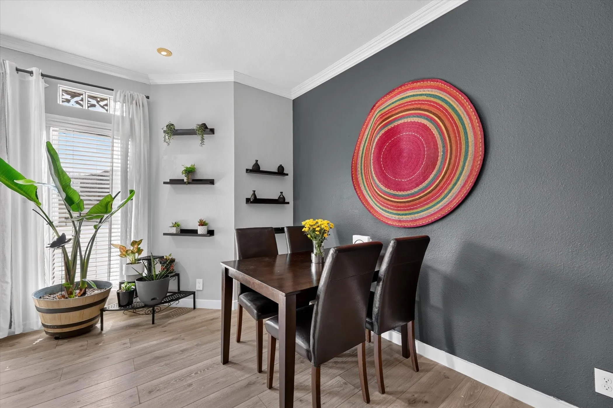 Crown molding, recessed lighting, wood-finish flooring, accent wall, and built-in shelving