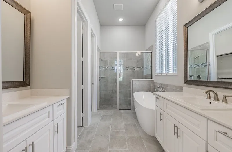 Dual vanities with undermount sinks and white cabinetry