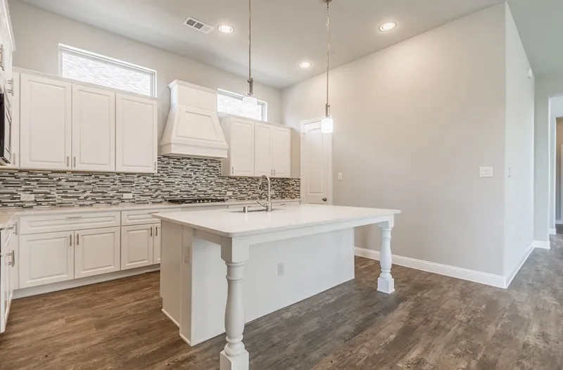 Kitchen featuring white shaker-style cabinetry, a mosaic tile backsplash, a center island with pendant lighting, recessed lighting, and wood-finish flooring