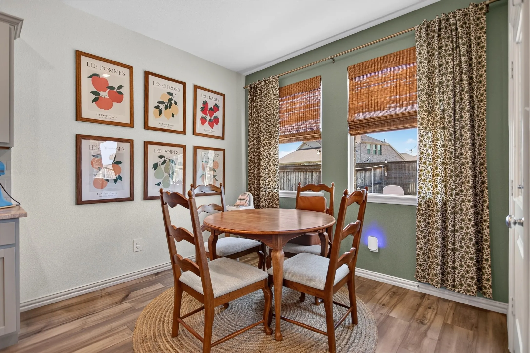 Wood-finish flooring with dual windows featuring natural woven blinds