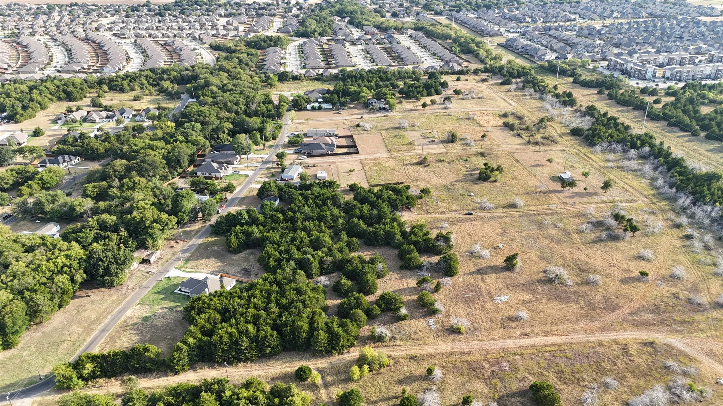 Expansive undeveloped land featuring mature trees and open fields