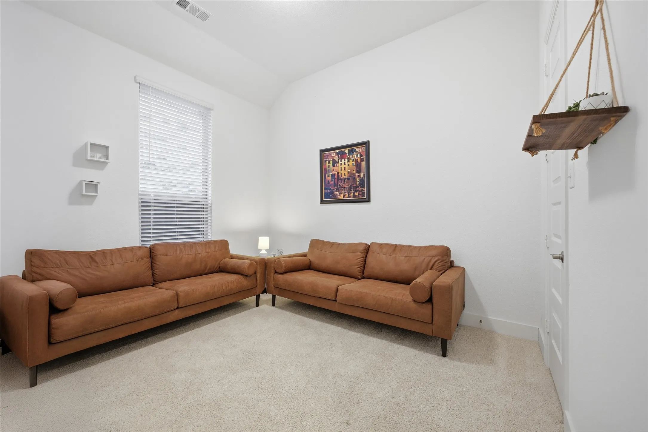 Vaulted ceiling with recessed lighting, light-colored carpeting, white walls, and a window with blinds