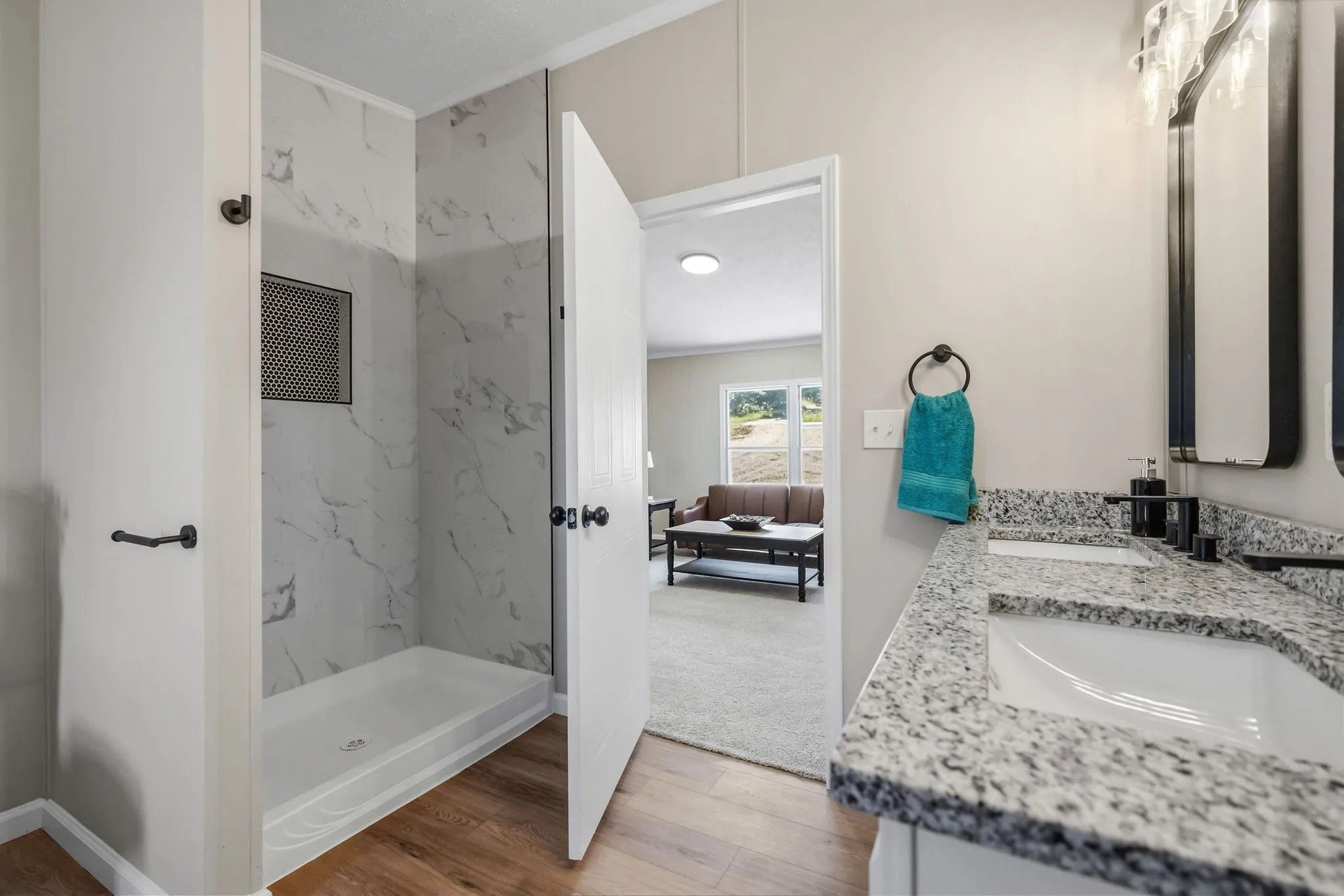 Double vanity with integrated sinks, granite-look countertop, and matte black fixtures