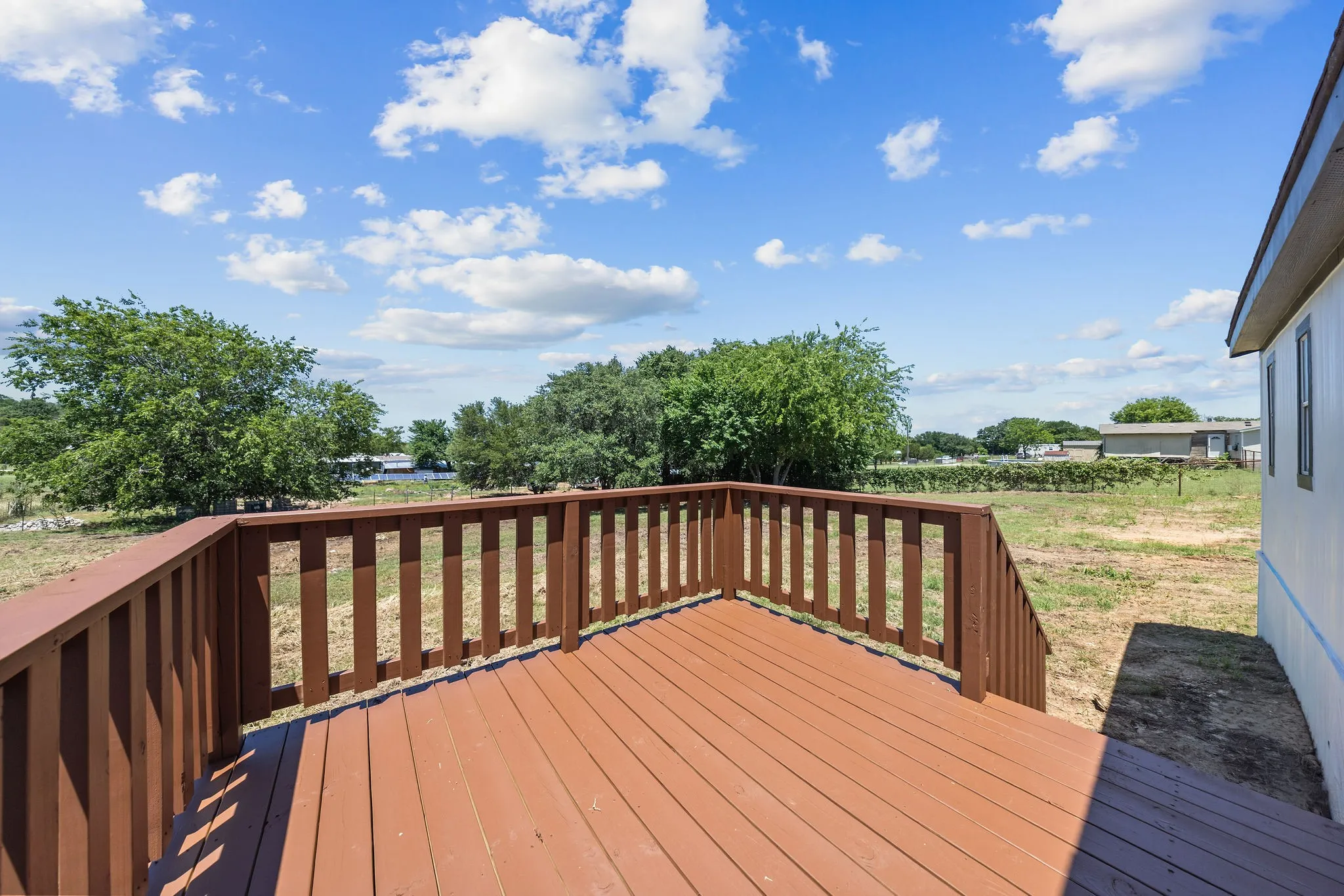 Outdoor deck with wood-finish flooring and railing