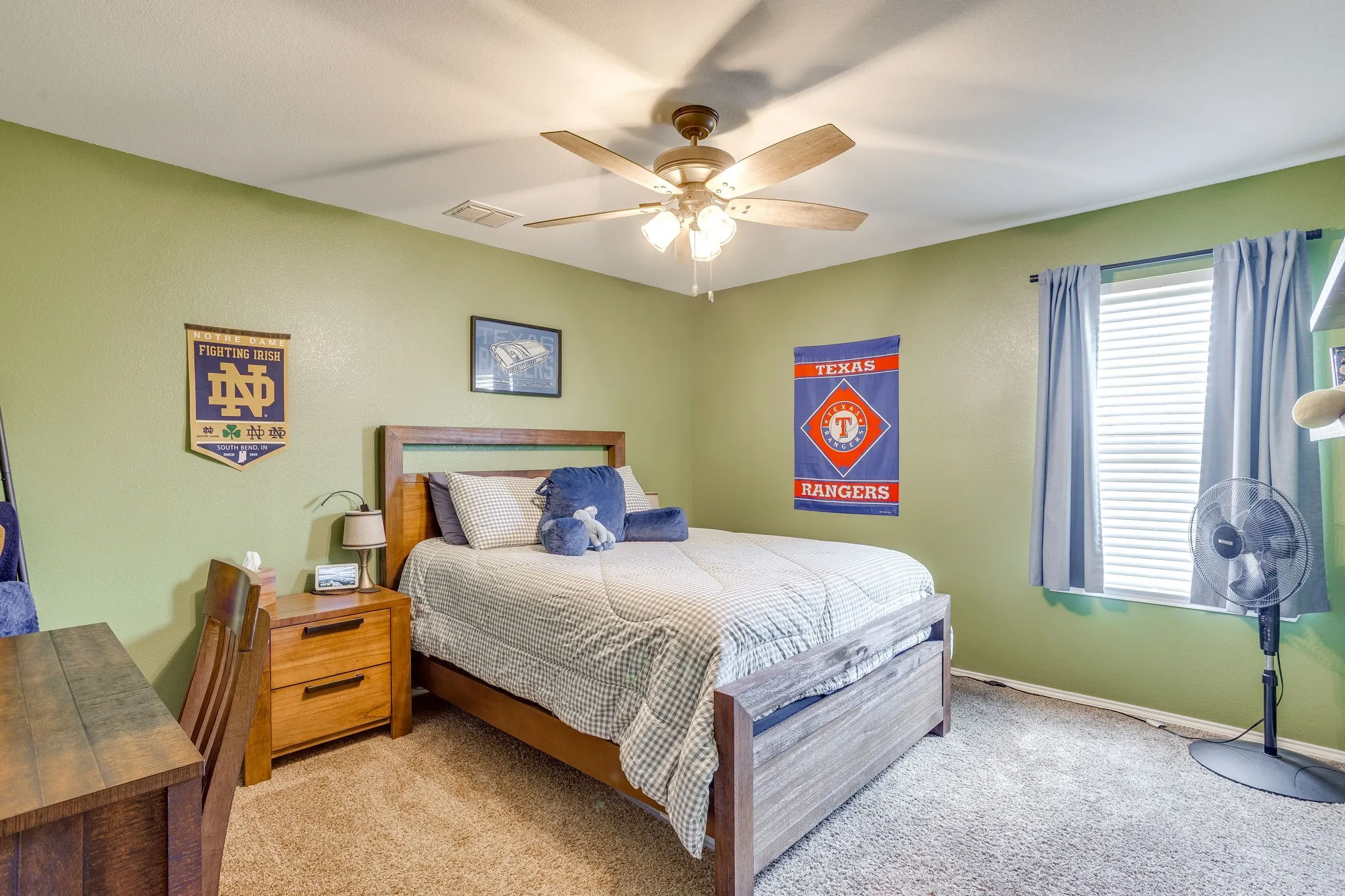 Recessed window with blinds, wood-finish ceiling fan with integrated lighting, and carpeted flooring