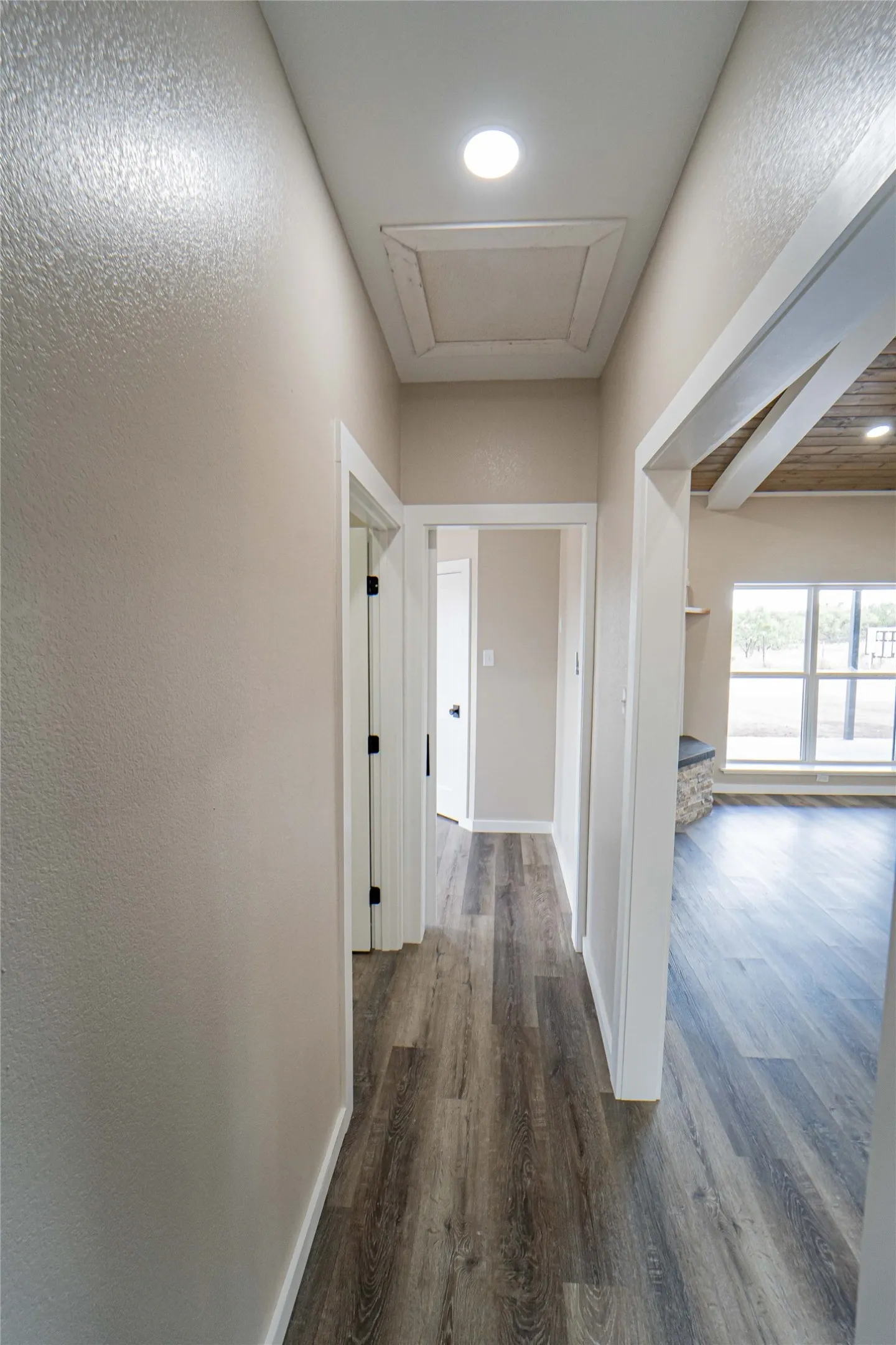 Wood-finish flooring throughout, recessed ceiling light, and white trim