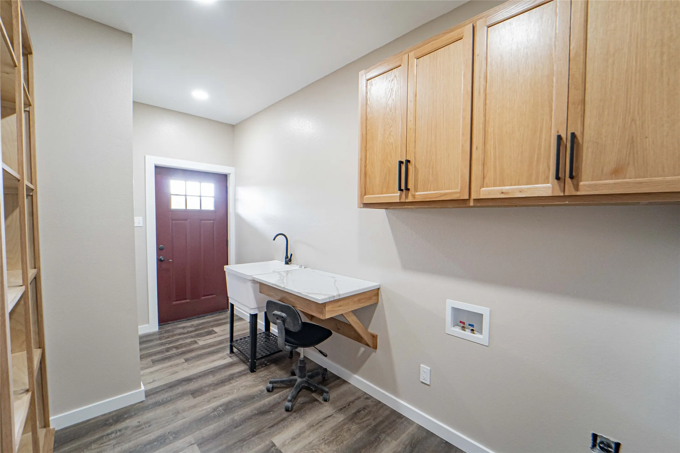 Pantry-Mudroom with utility sink with matte black faucet, wood-finish flooring, white countertop, built-in shelving, and recessed lighting