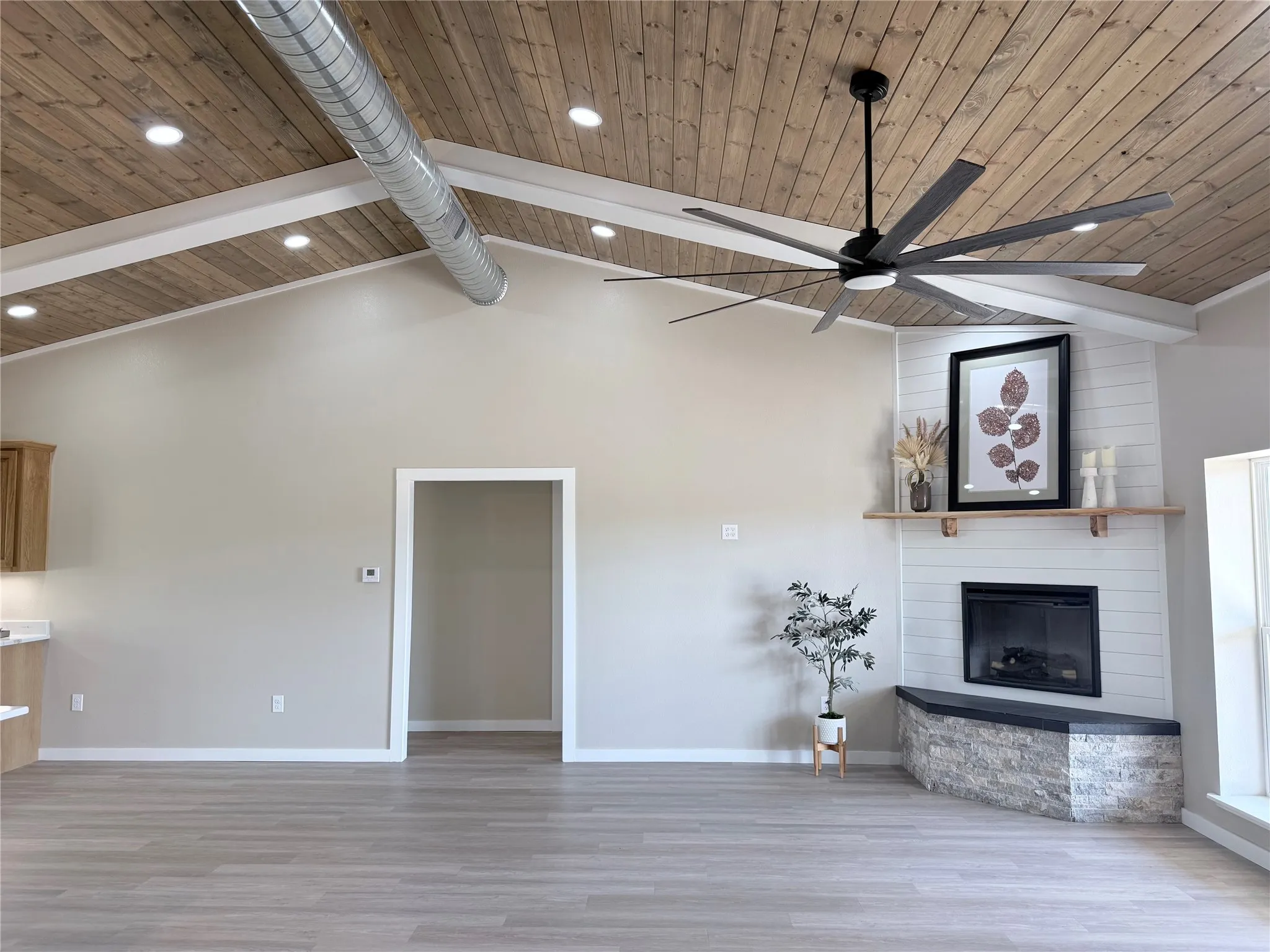 Living room with electric fireplace and vaulted celings