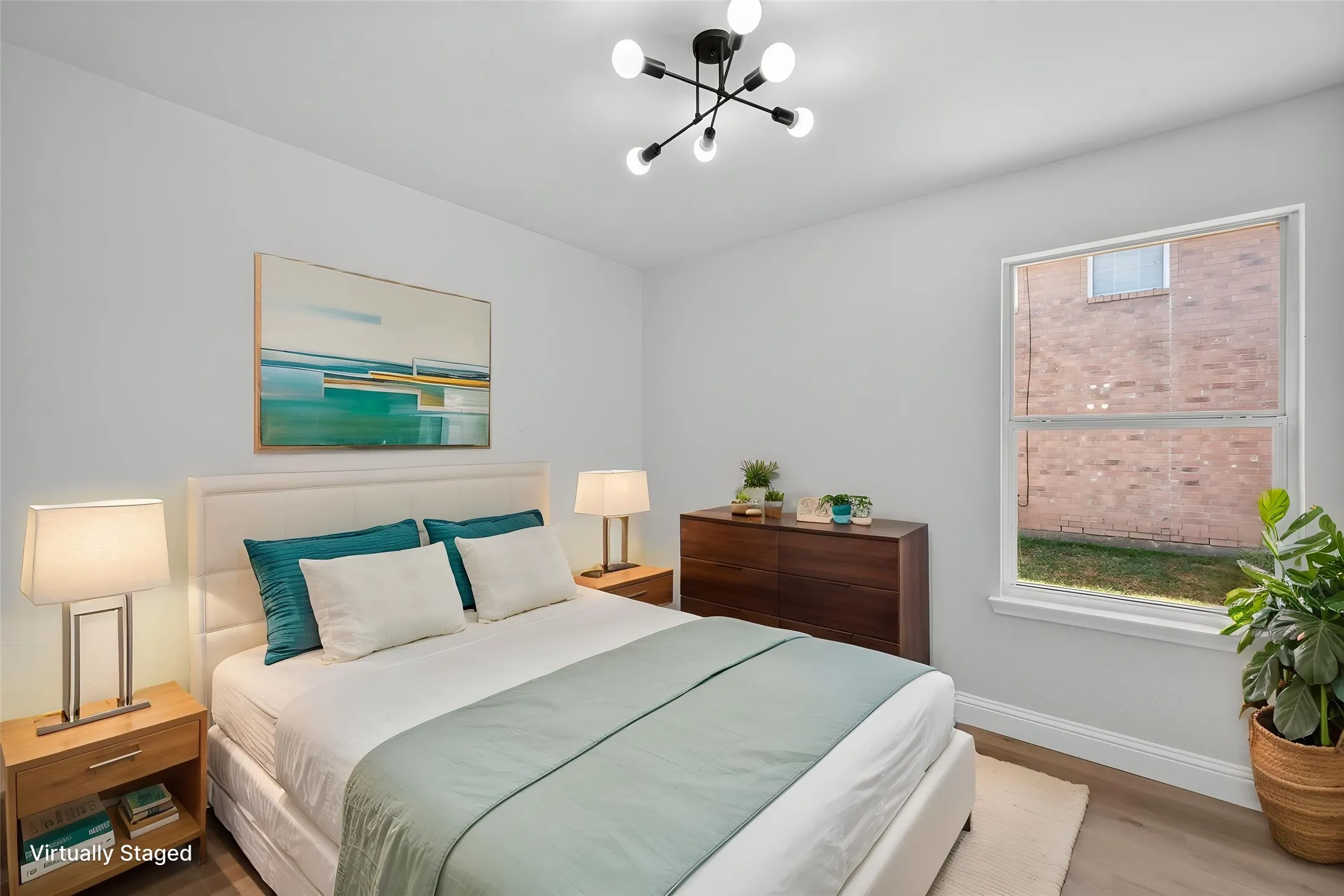 Wood-finish flooring throughout, a large window providing natural light, and a contemporary ceiling light fixture
