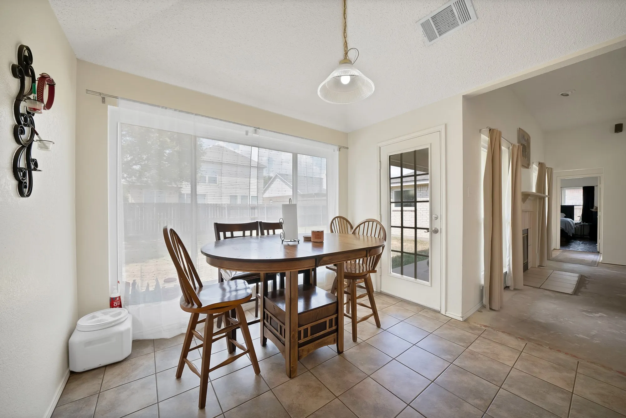 Recessed lighting and a single pendant light fixture illuminate the space