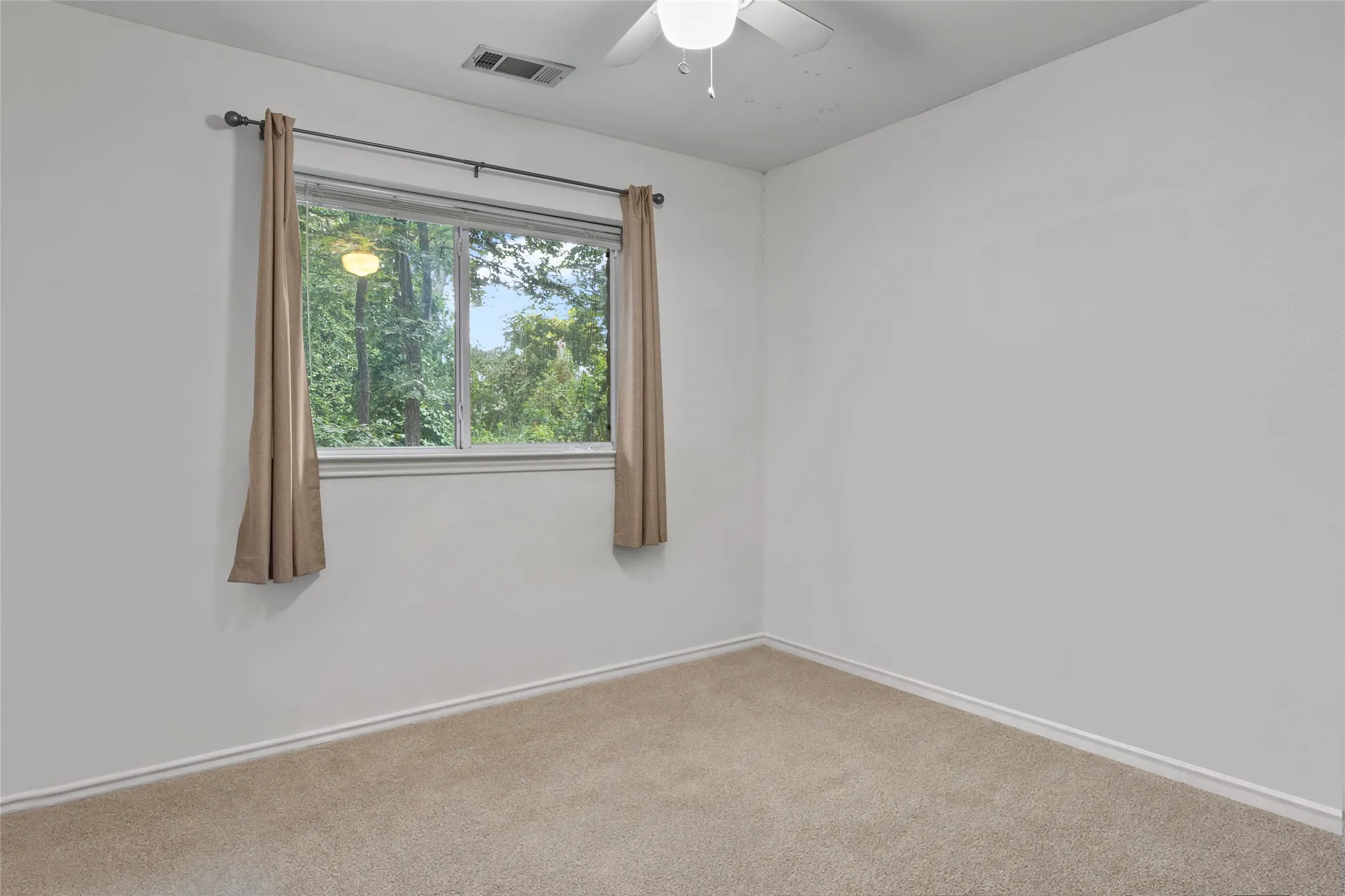 STAGE Carpeted flooring, white painted walls, and a ceiling fan