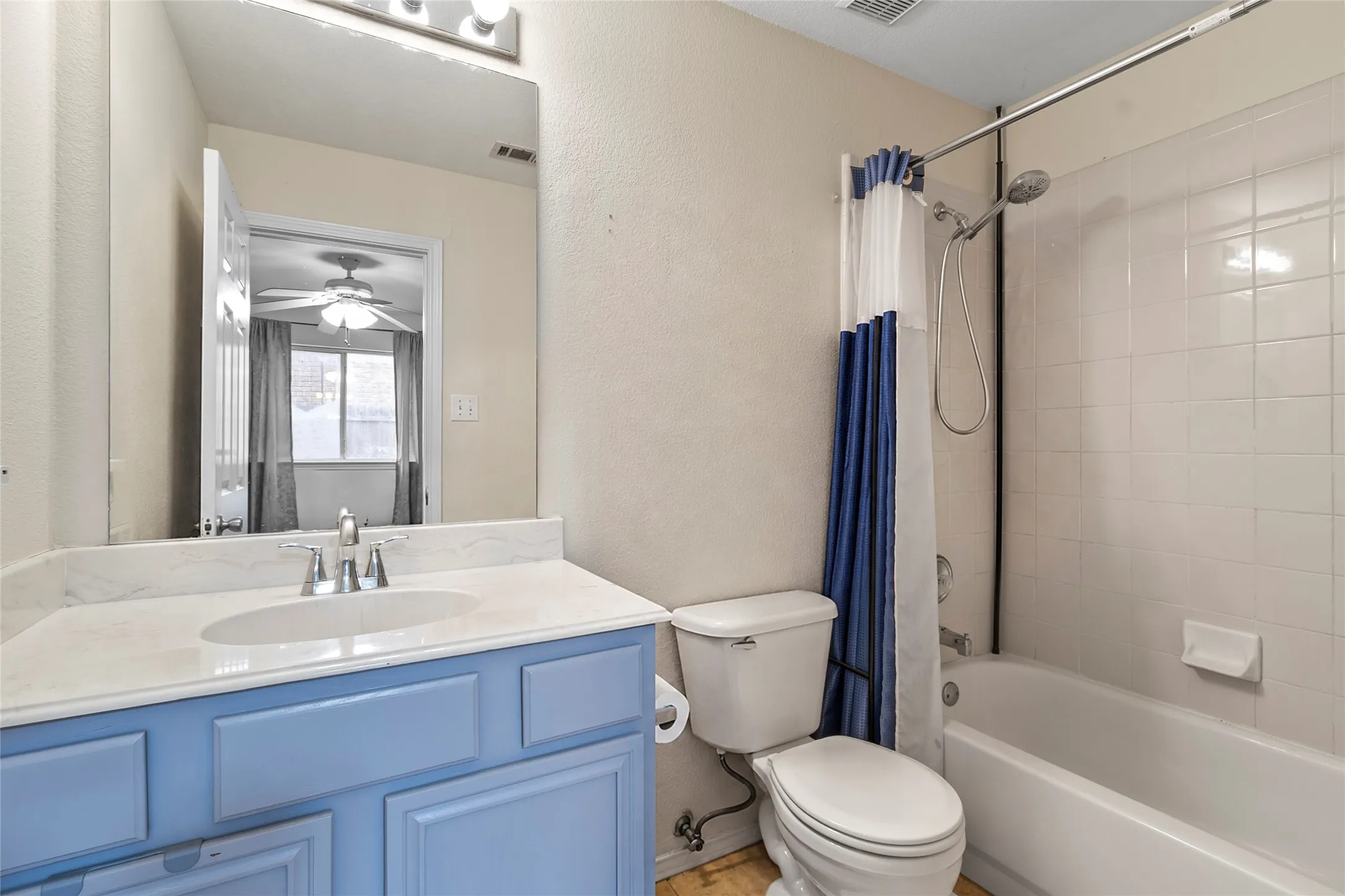 STAGE Vanity with light blue cabinetry, white countertop, and integrated sink with chrome​​‌​​​​‌​​‌‌​‌‌​​​‌‌​‌​‌​‌​​​‌​​ faucet