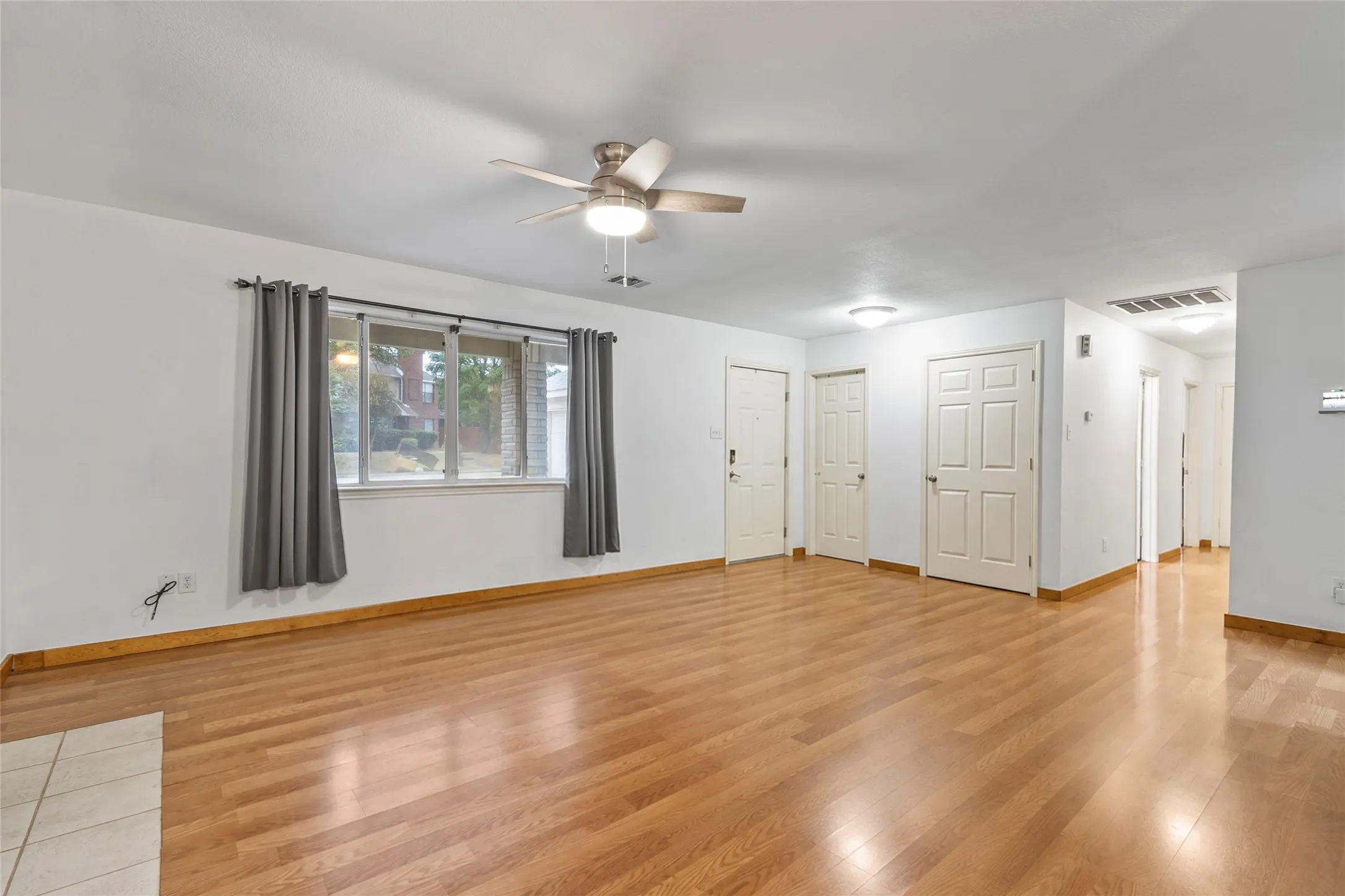STAGE Wood-finish flooring throughout, ceiling fan with integrated lighting, recessed lighting, and multiple interior doors