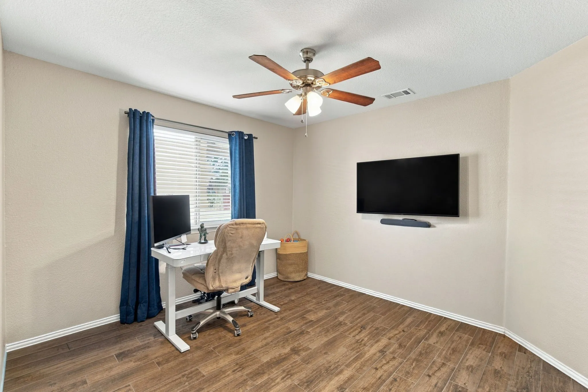 Wood-finish flooring, ceiling fan, and window with blinds