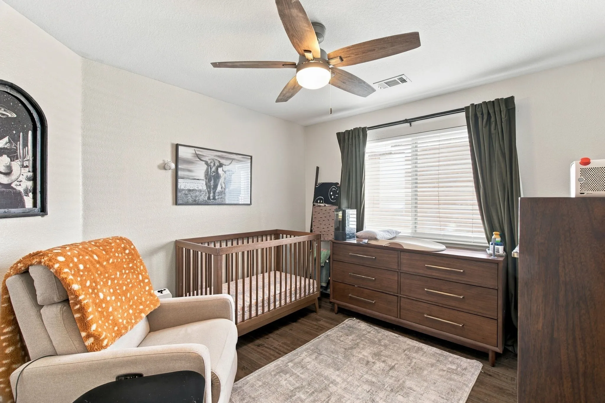 Wood-finish flooring with a ceiling fan light fixture