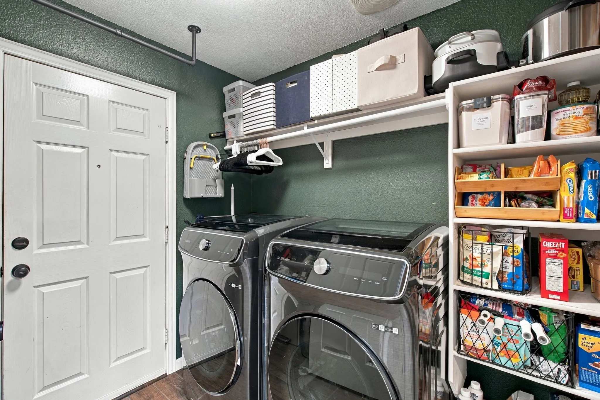 Built-in shelving, mounted clothes rod, and white panel door with dark hardware