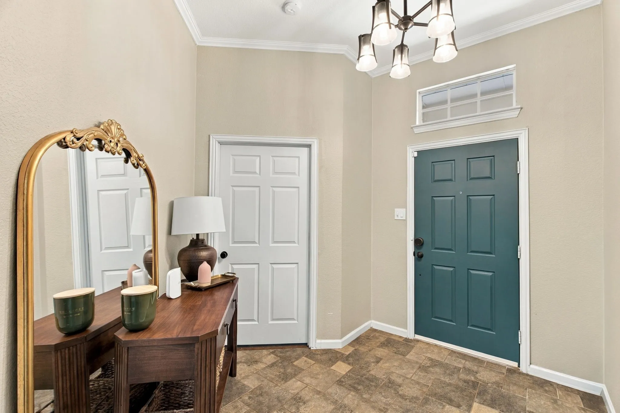 Entryway featuring a paneled door, transom window, and crown molding